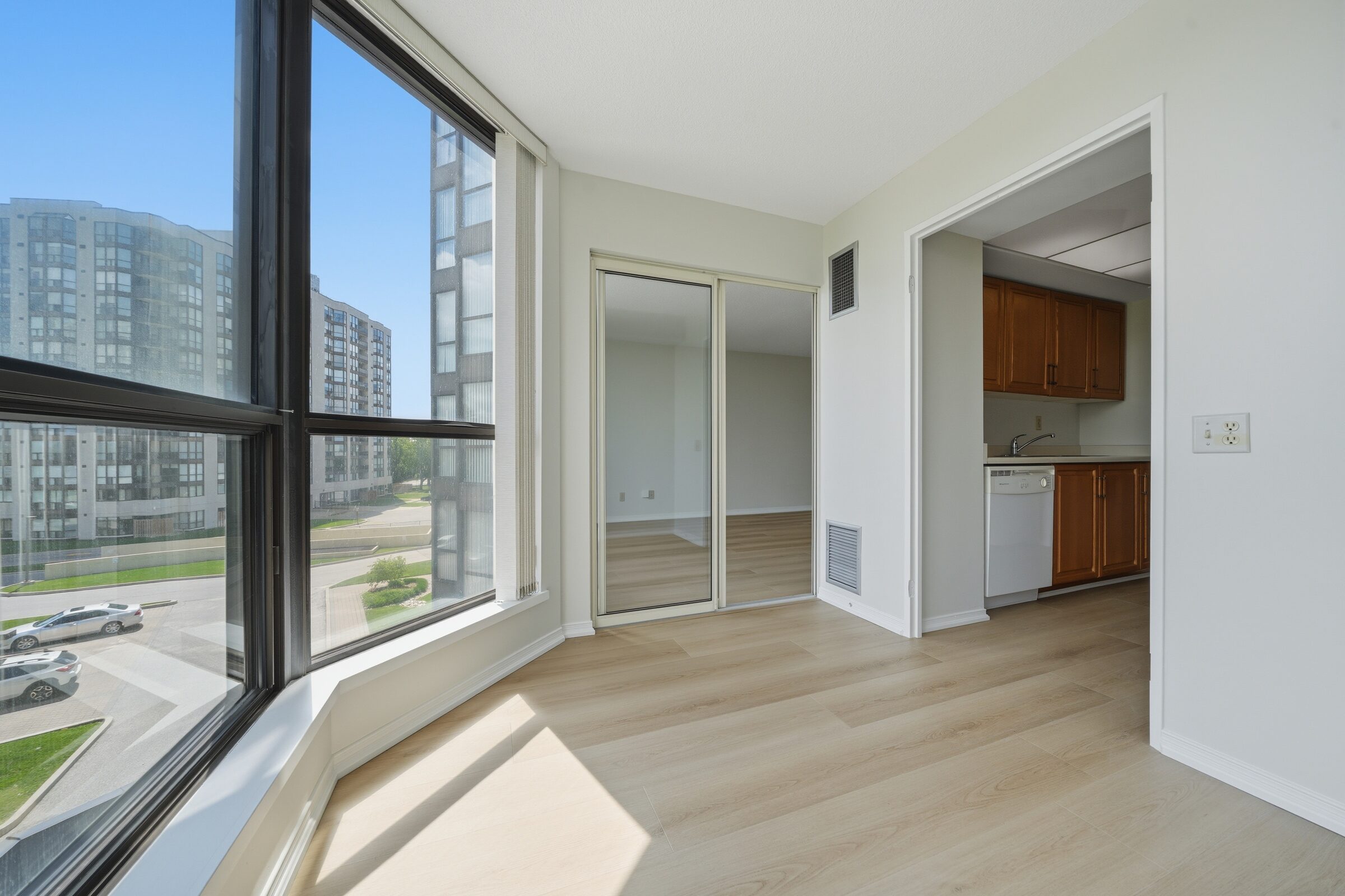 Living area with new engineered flooring and large windows