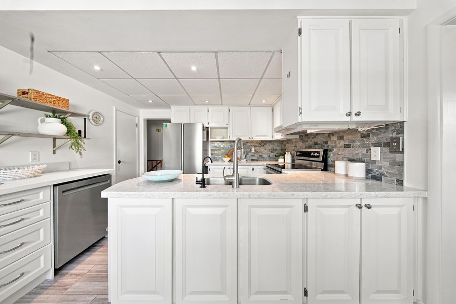 Eat-in kitchen with quartz counters and stainless appliances — 16 Oldham Road