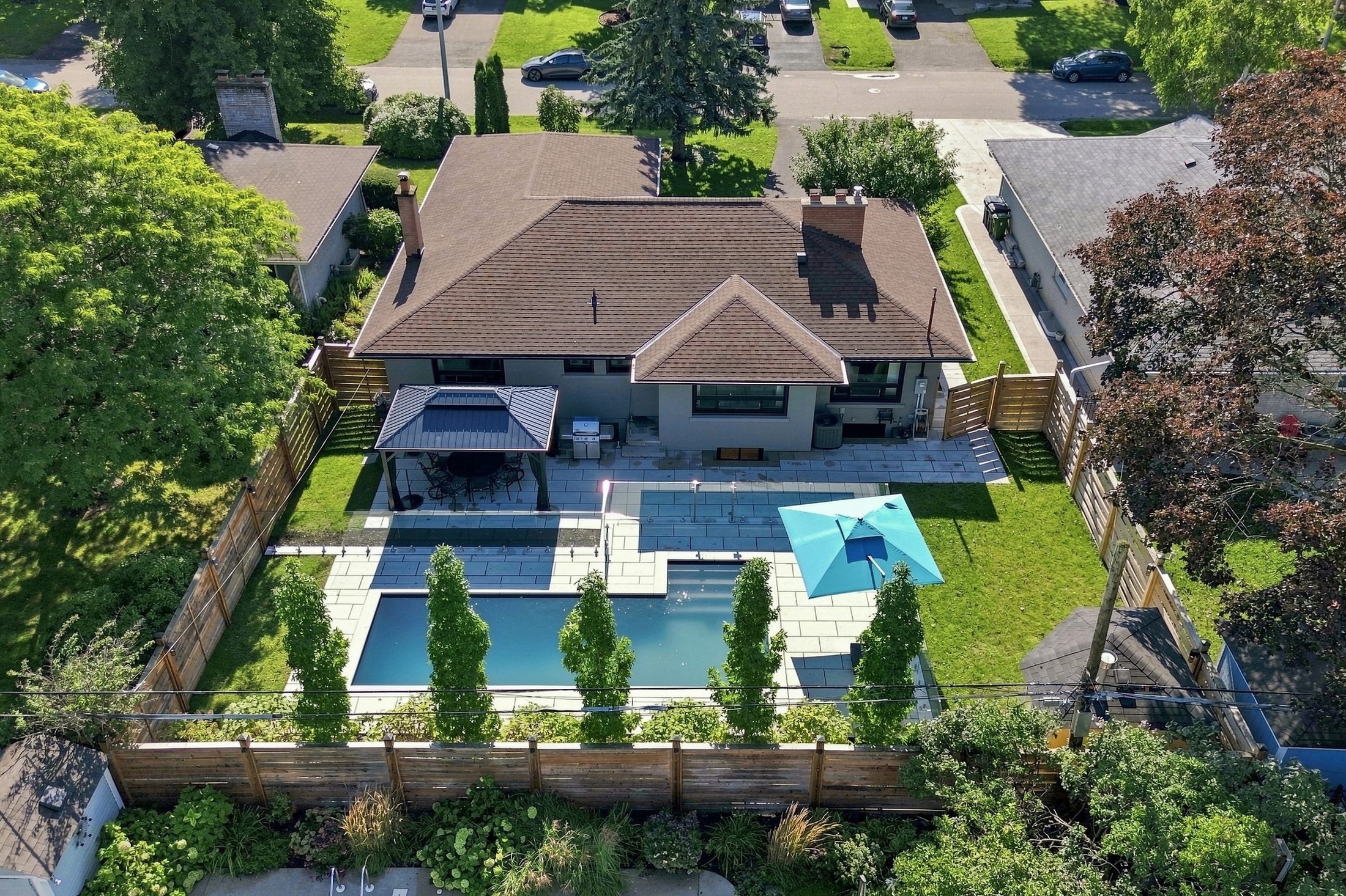 Aerial view of 16 Oldham Road showing the house, pool terrace and south-facing lot