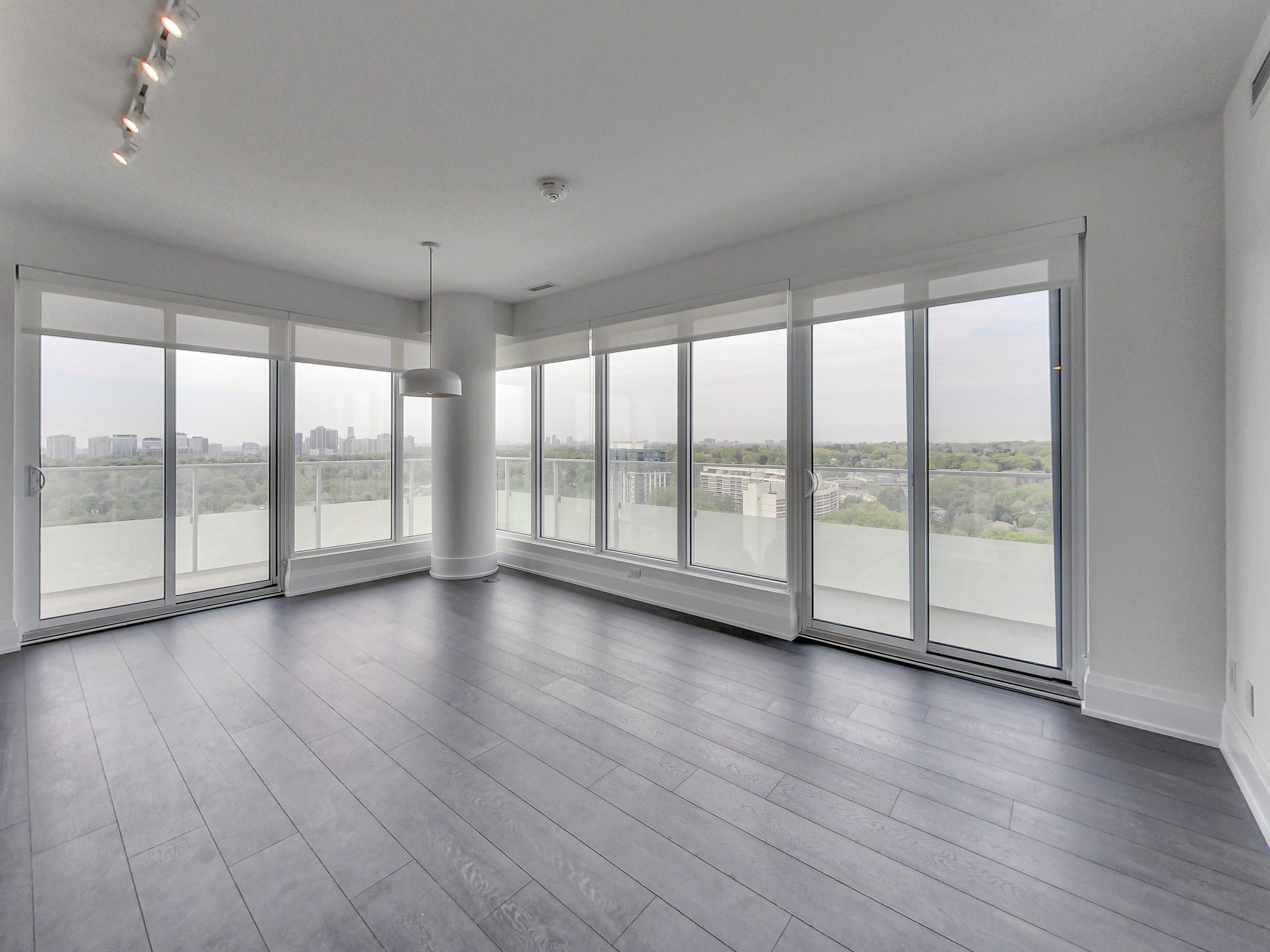 Floor-to-ceiling windows carry light across the principal living space