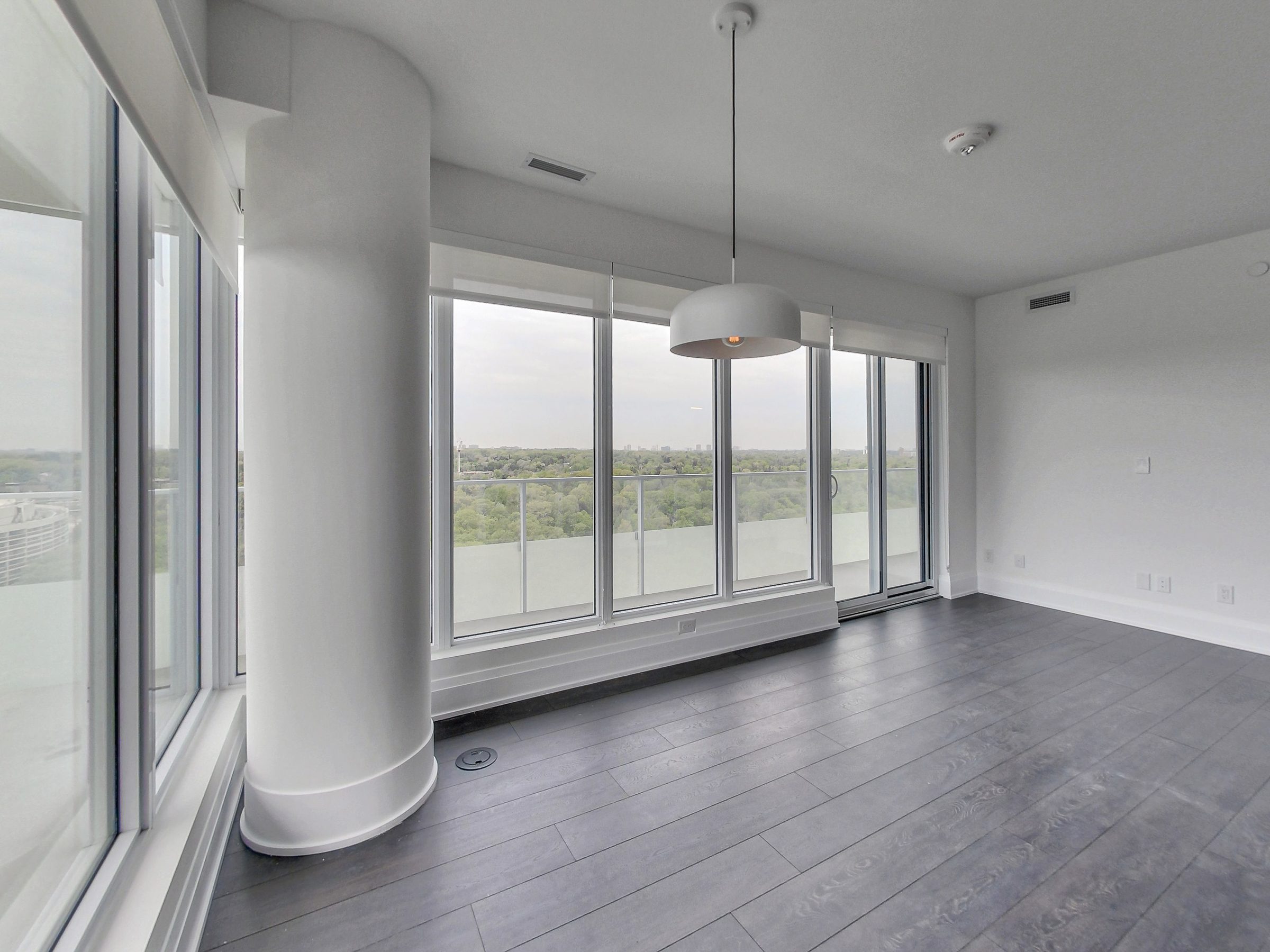 Open living area with a sculptural column and valley views