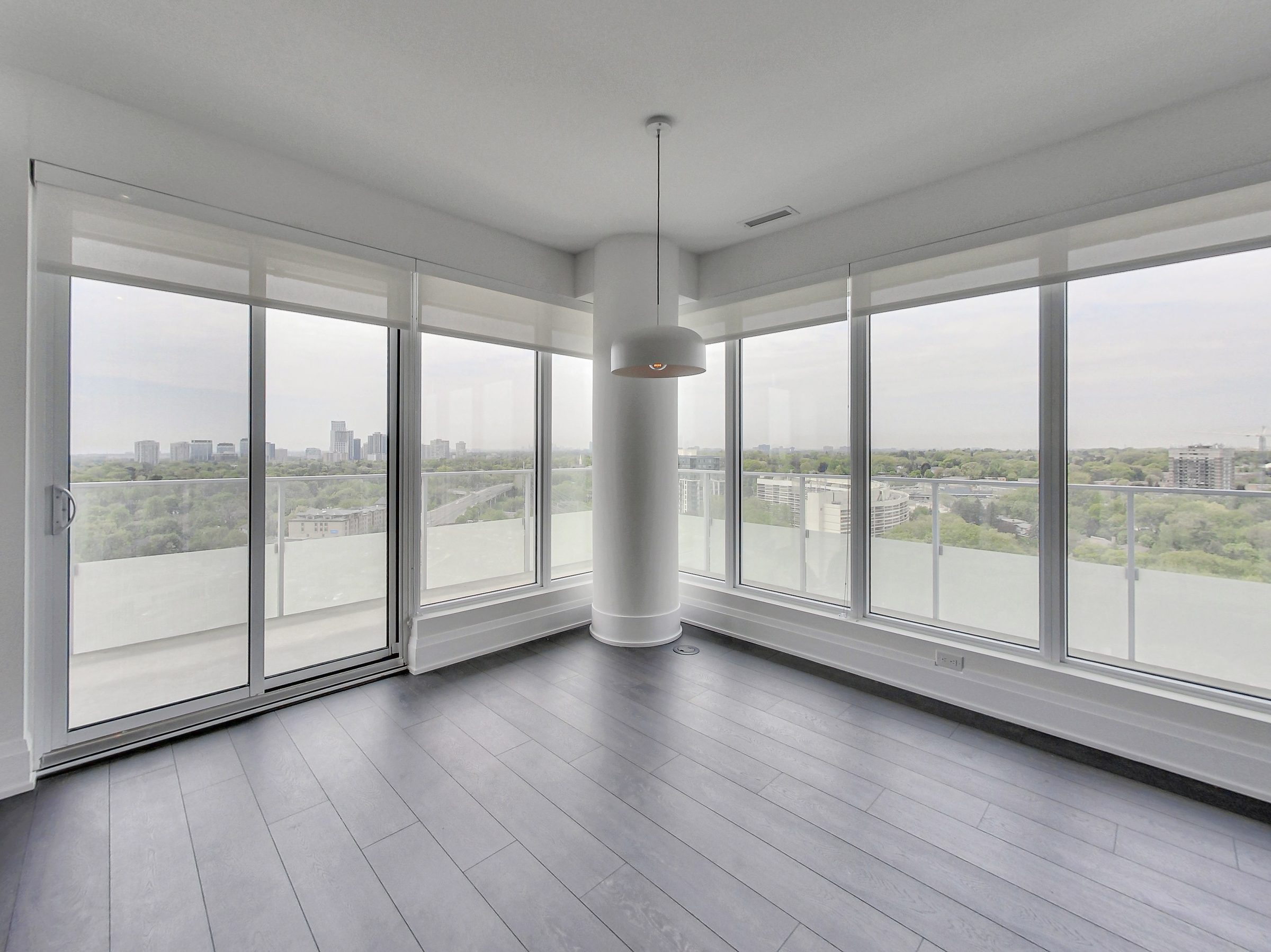 Corner living room wrapped in floor-to-ceiling glass over the Humber Valley