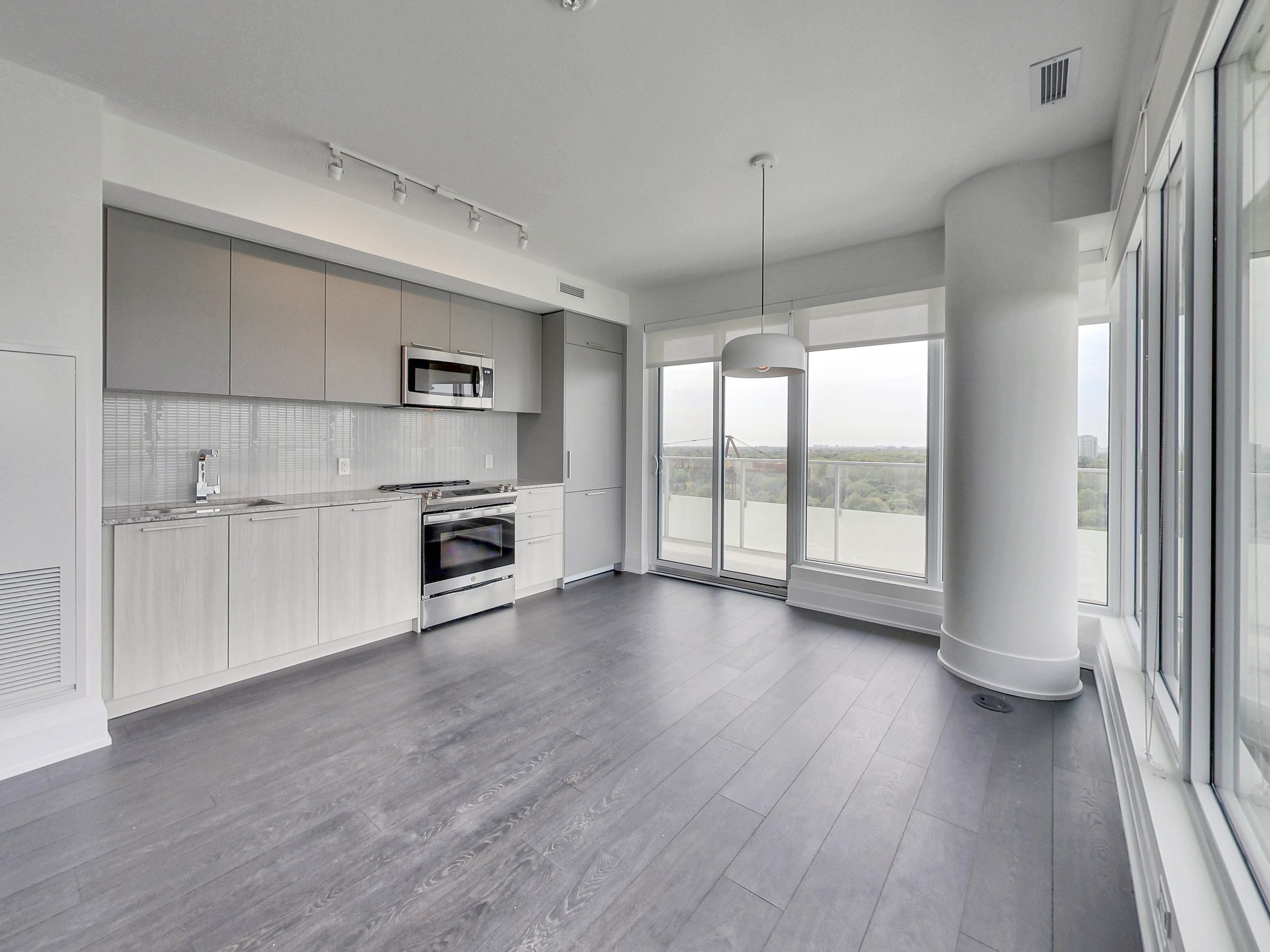 The chef's kitchen opens to the living space and the view beyond