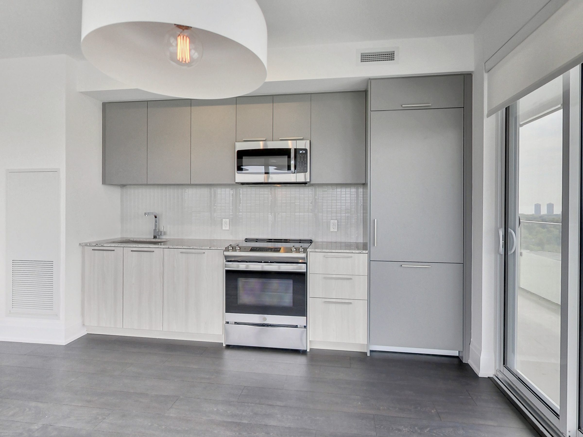 Integrated stainless appliances and full-height cabinetry