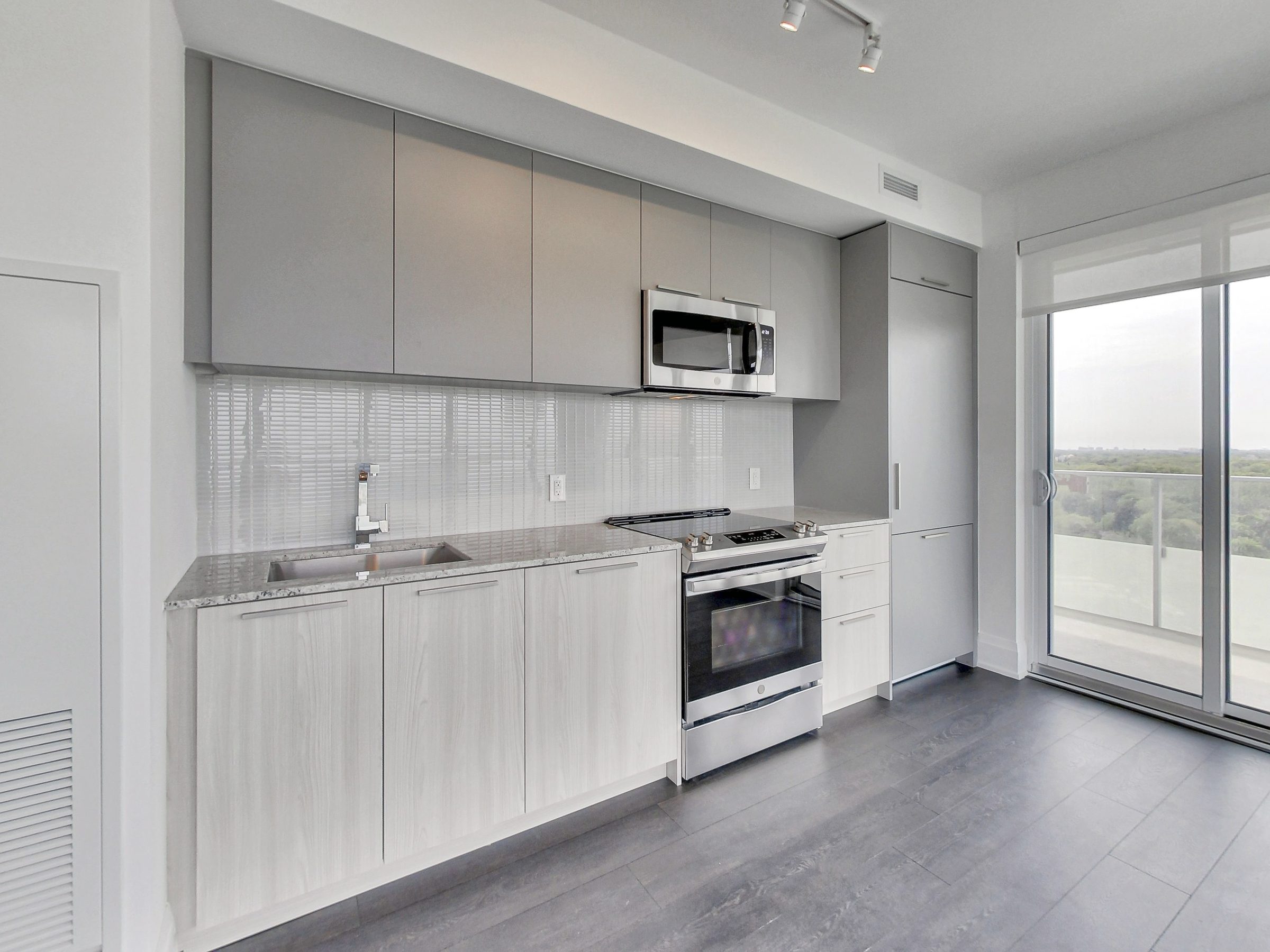Kitchen with natural light and treetop views