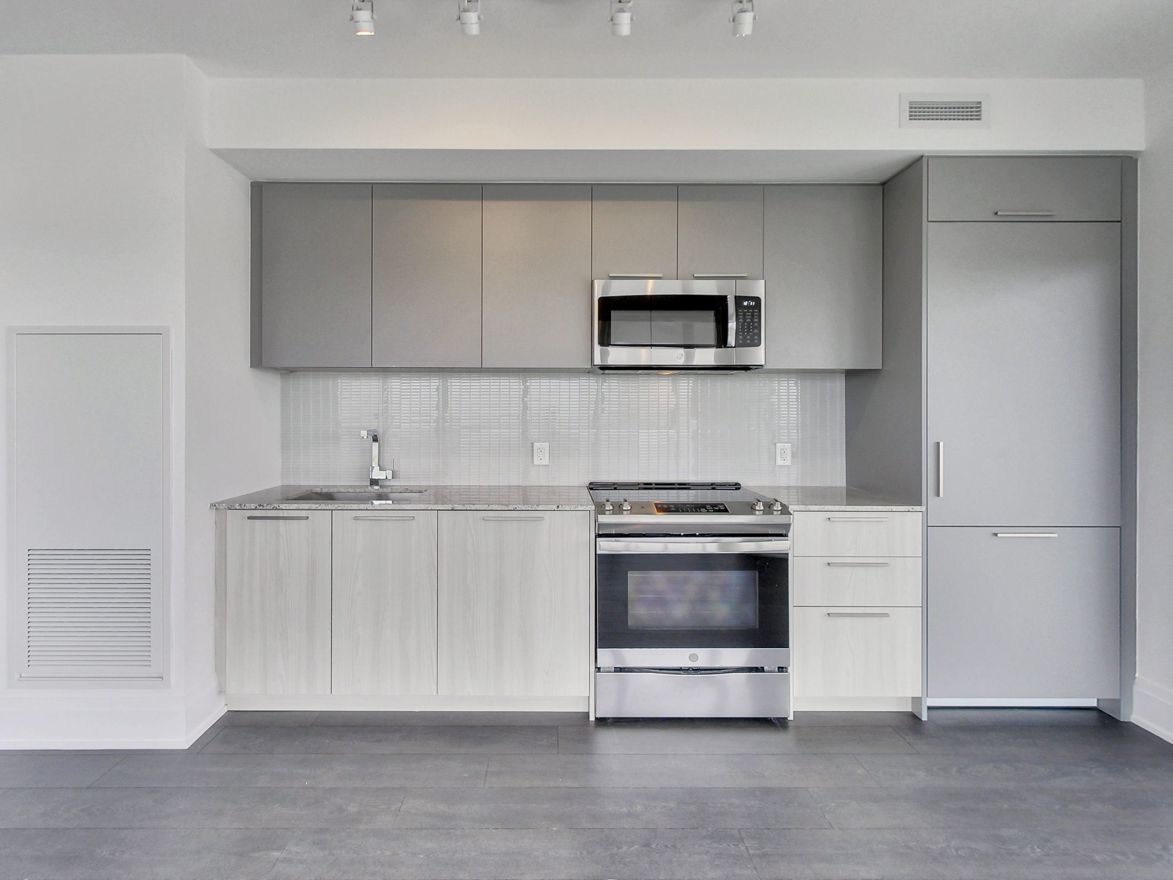 Stone counters and a clean, contemporary kitchen palette