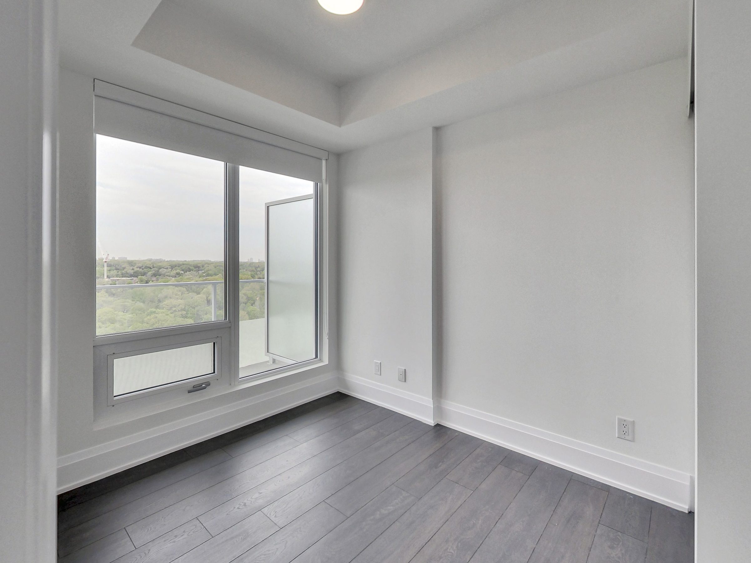Corner bedroom with oversized windows and an open outlook