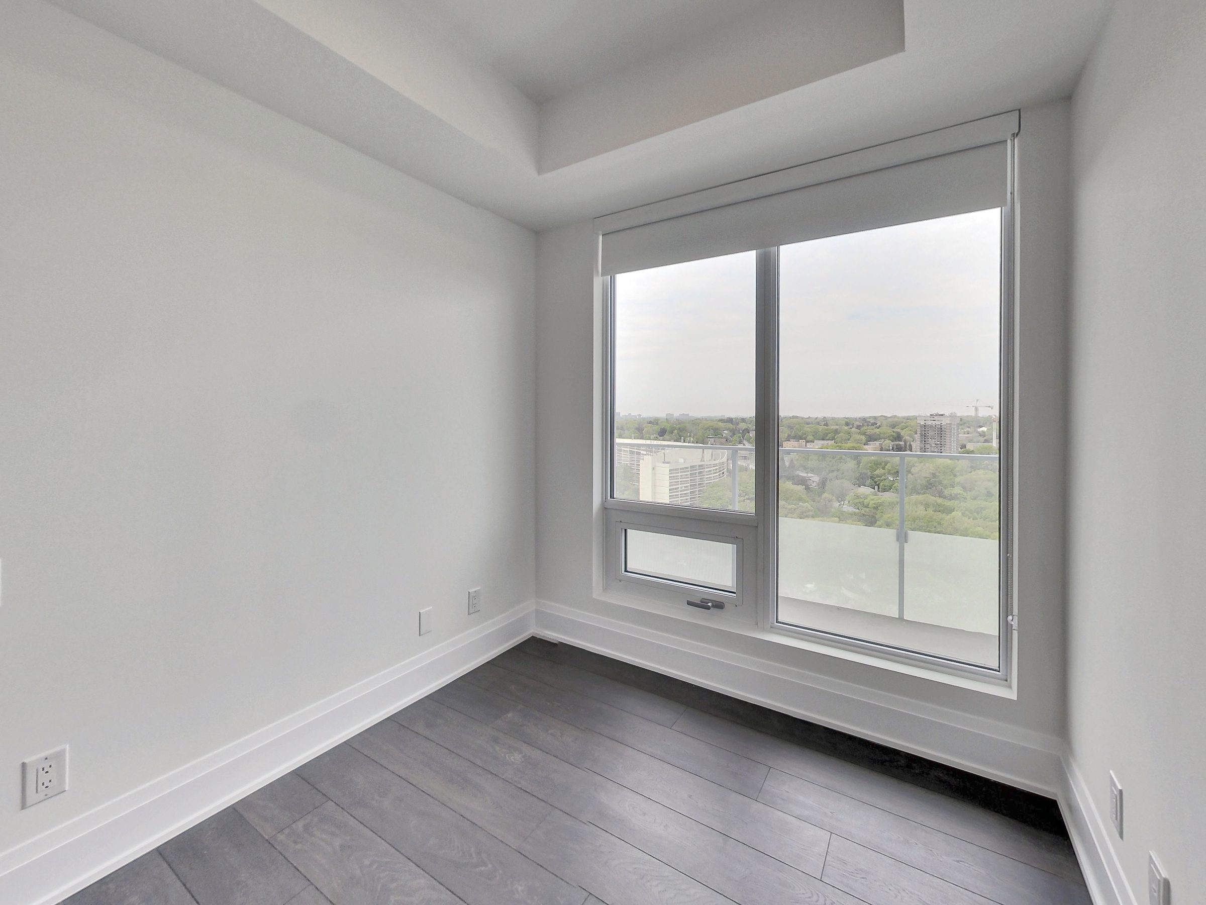 Bedroom with a tray ceiling and generous glazing