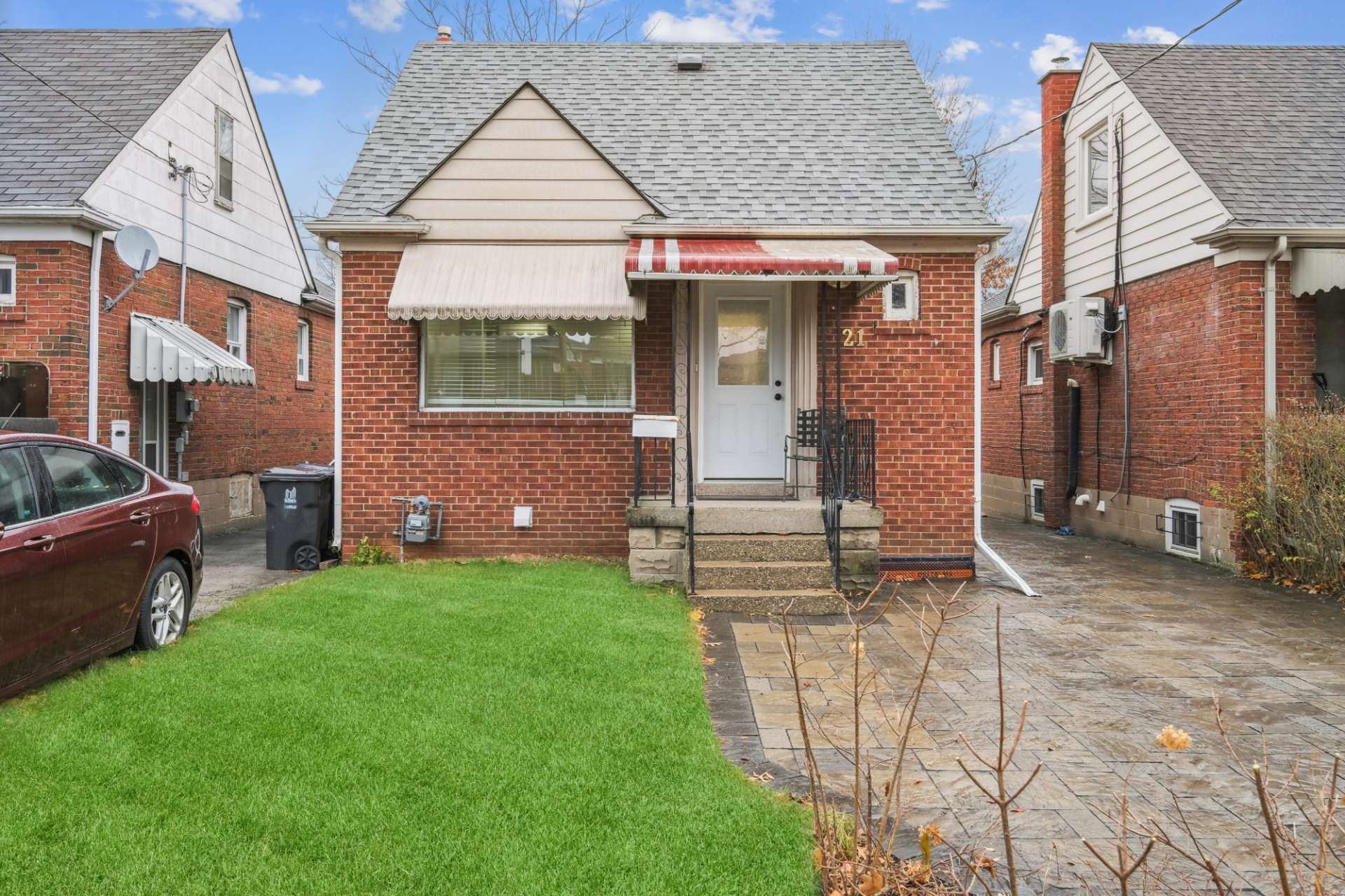 Brick detached home with private drive and front lawn