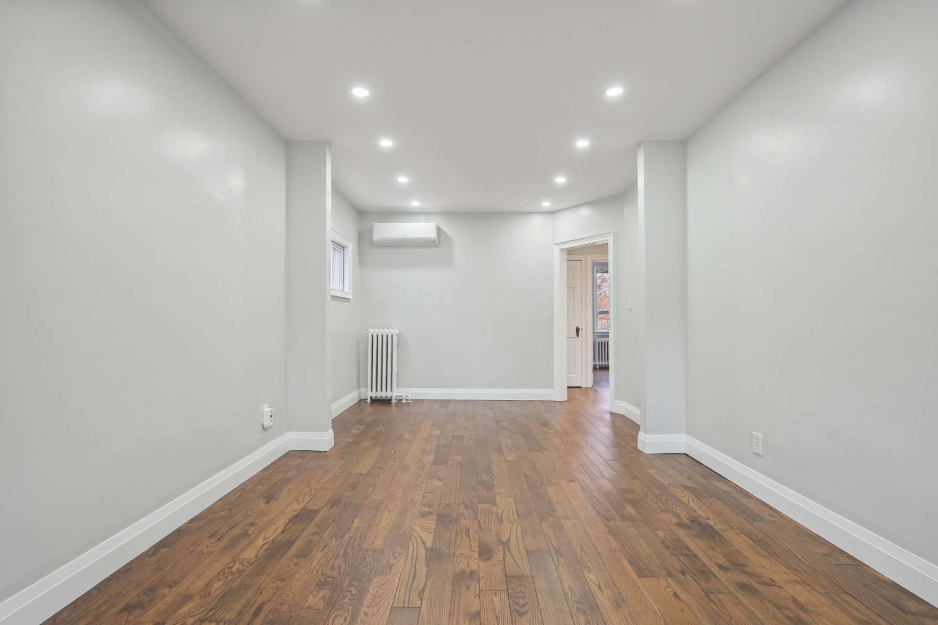Sun-filled living room with wide-plank floors