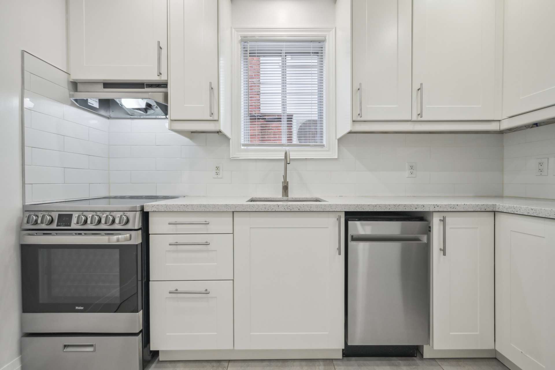 Renovated kitchen with quartz counters and stainless appliances