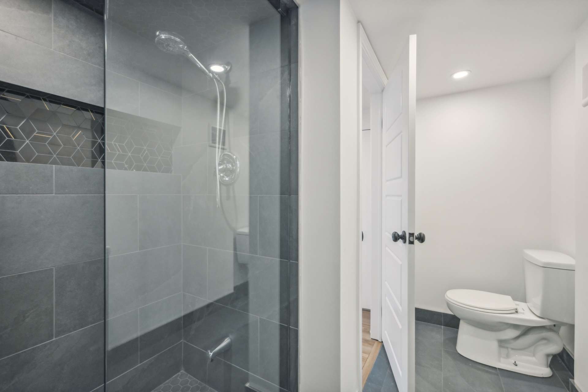 Walk-in glass shower with tiled surround
