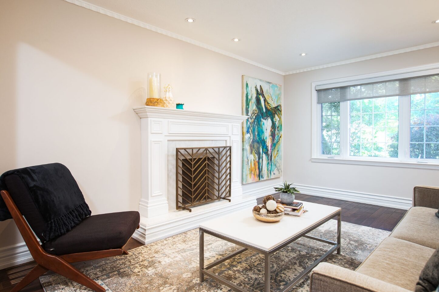 Open-plan living room with wood-burning fireplace and custom mantle
