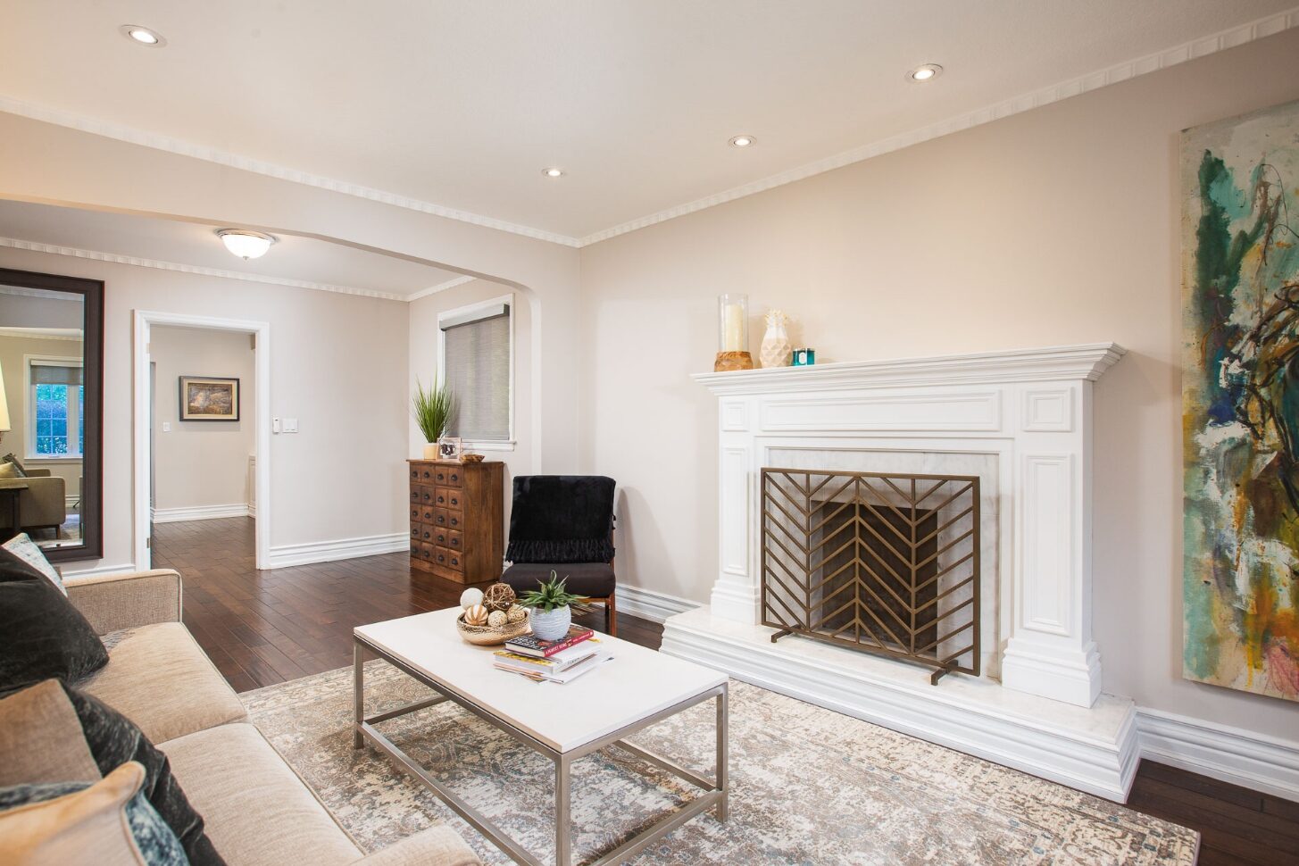 Sun-filled living room with hardwood floors and large windows