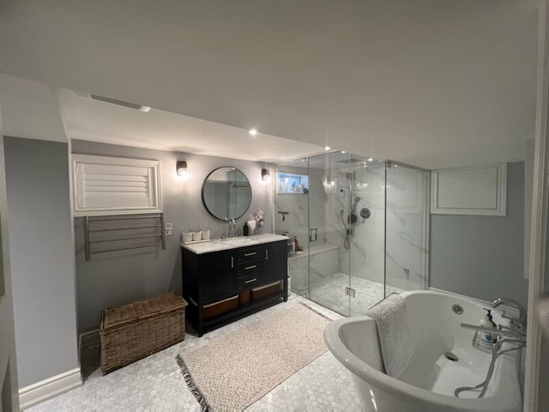 Lower-level spa bathroom with steam shower and soaker tub