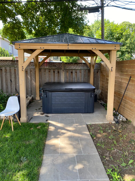 Cedar pergola sheltering the outdoor spa