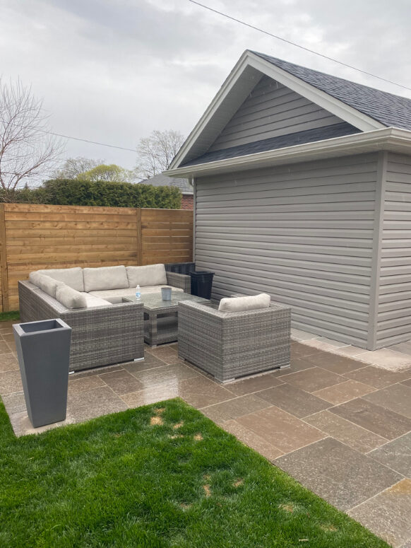 Private backyard patio beside the detached garage