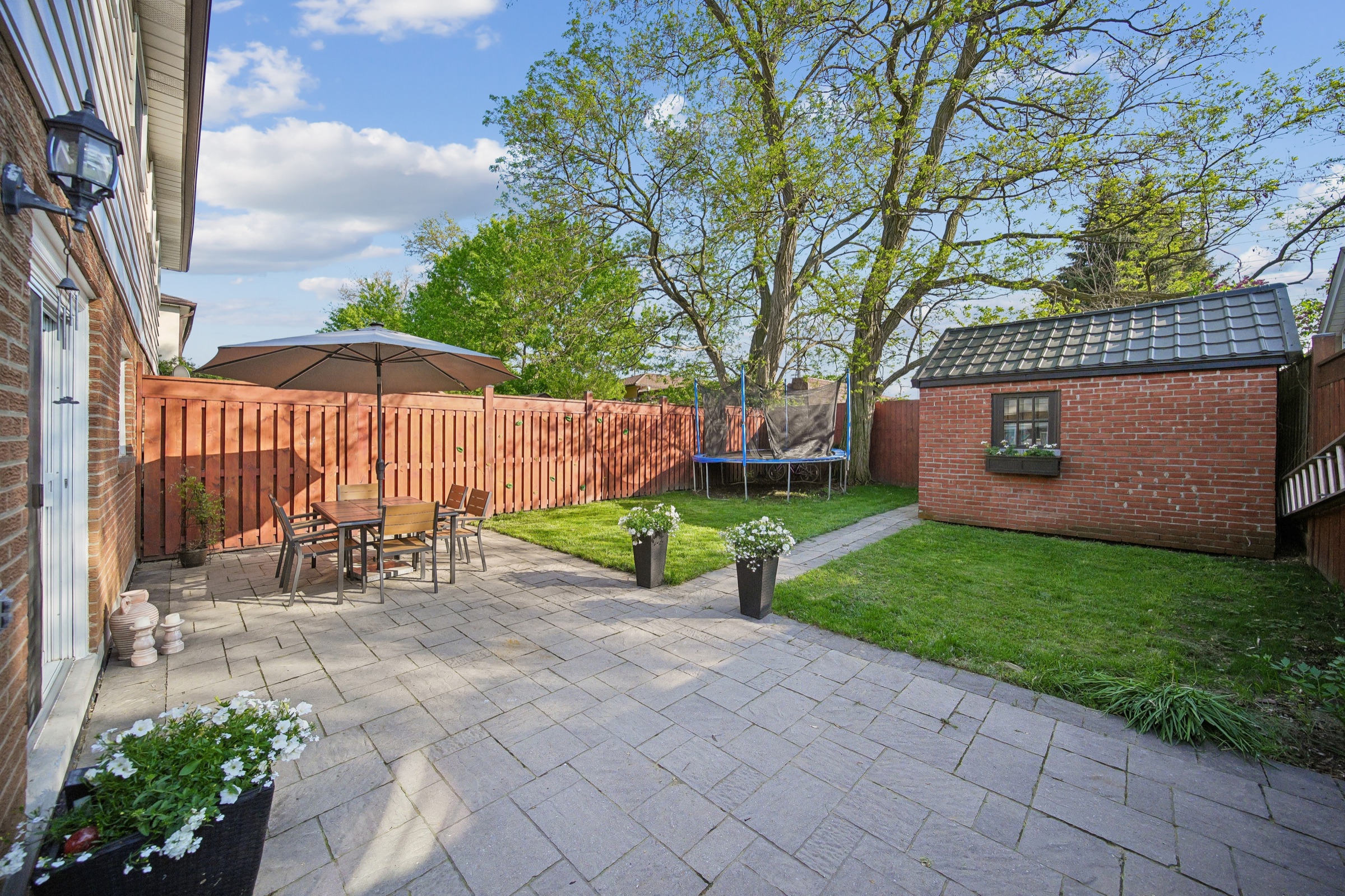 Landscaped backyard with patio and shed