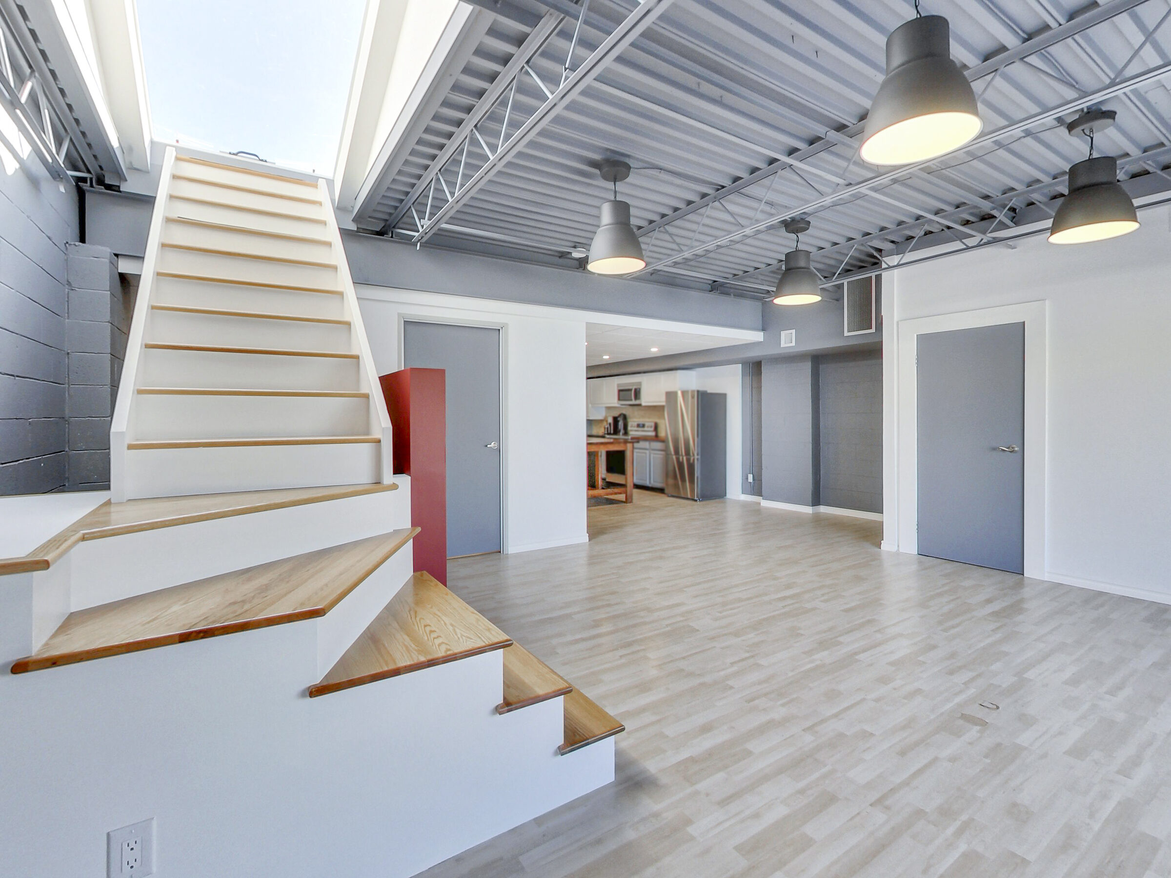 Staircase rising to the rooftop deck