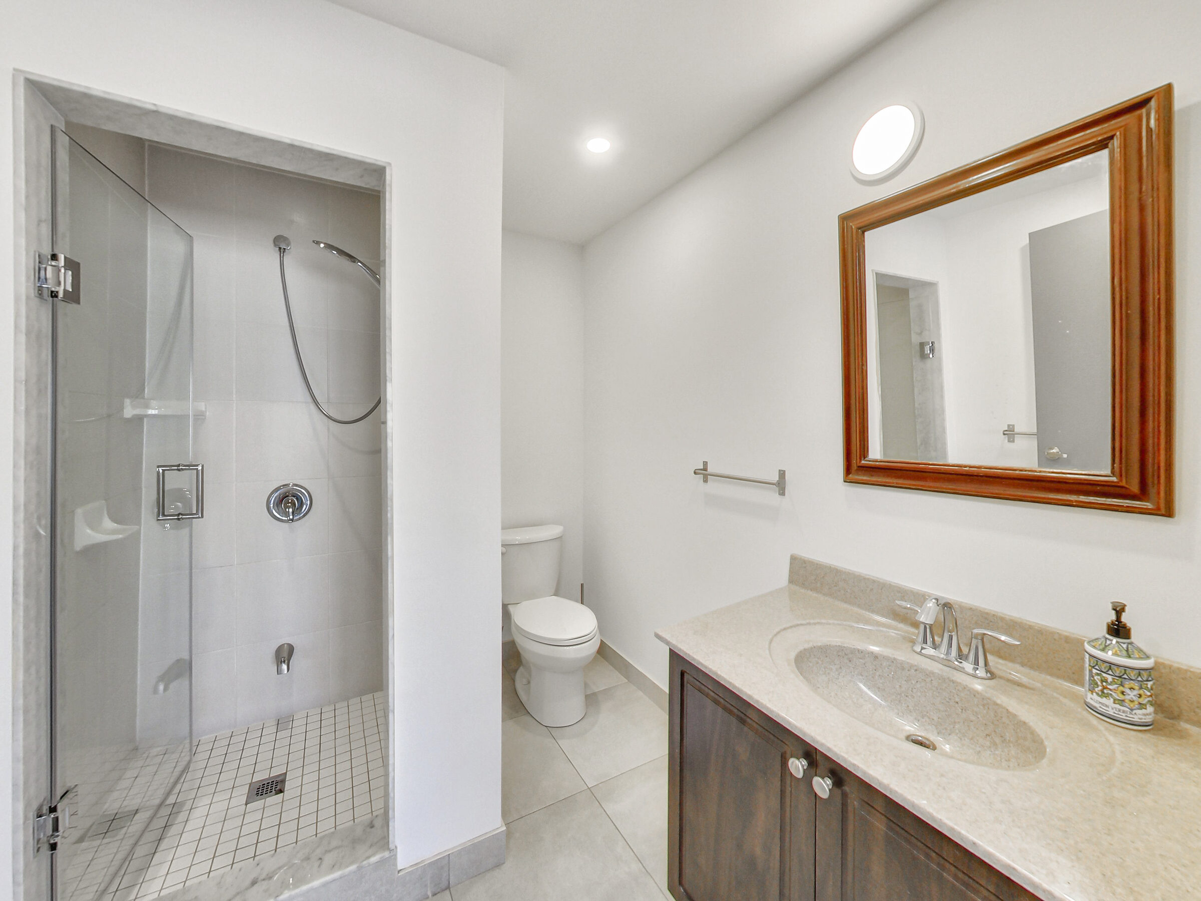 Full bathroom with glass shower and vanity