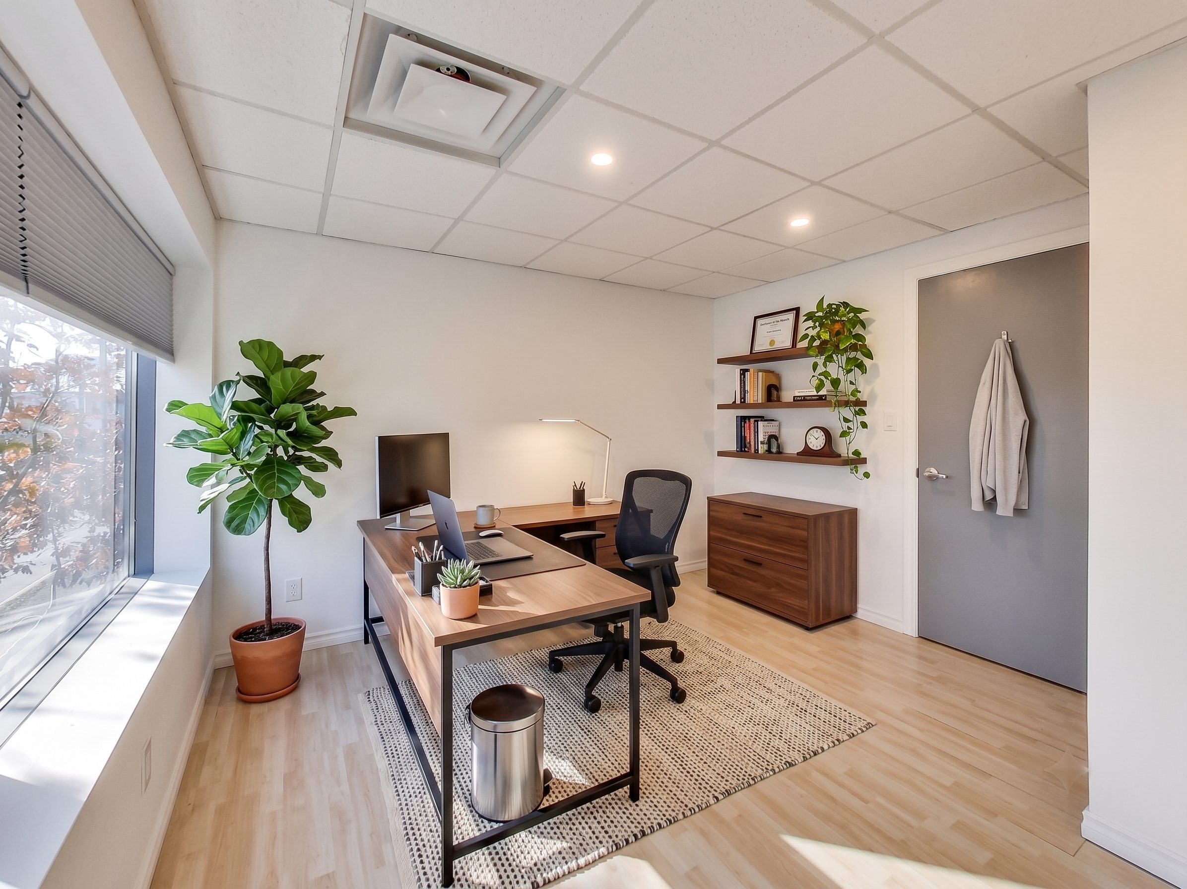 Private professional office staged with an executive L-desk