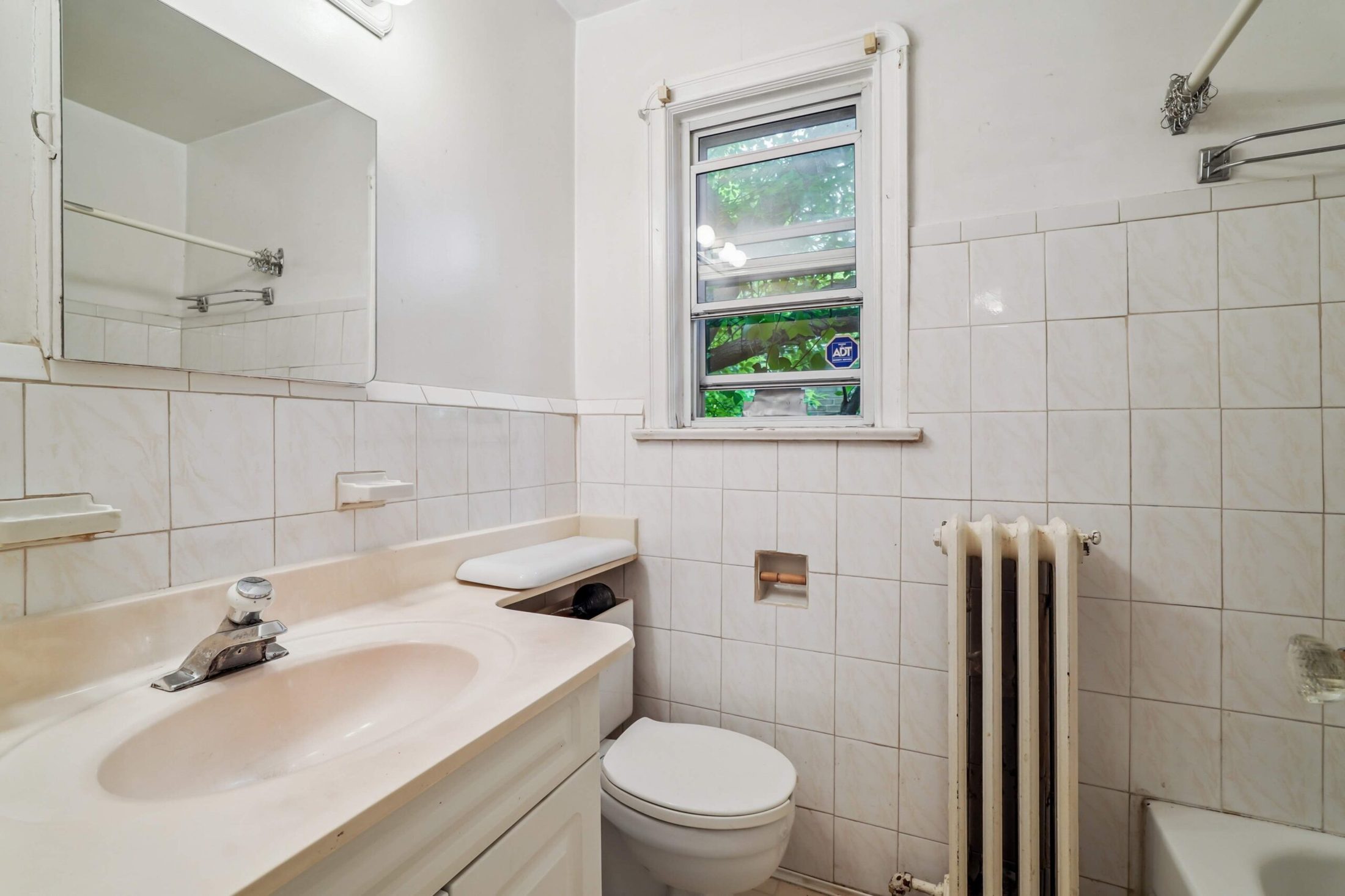 Full bathroom with classic tile and natural light