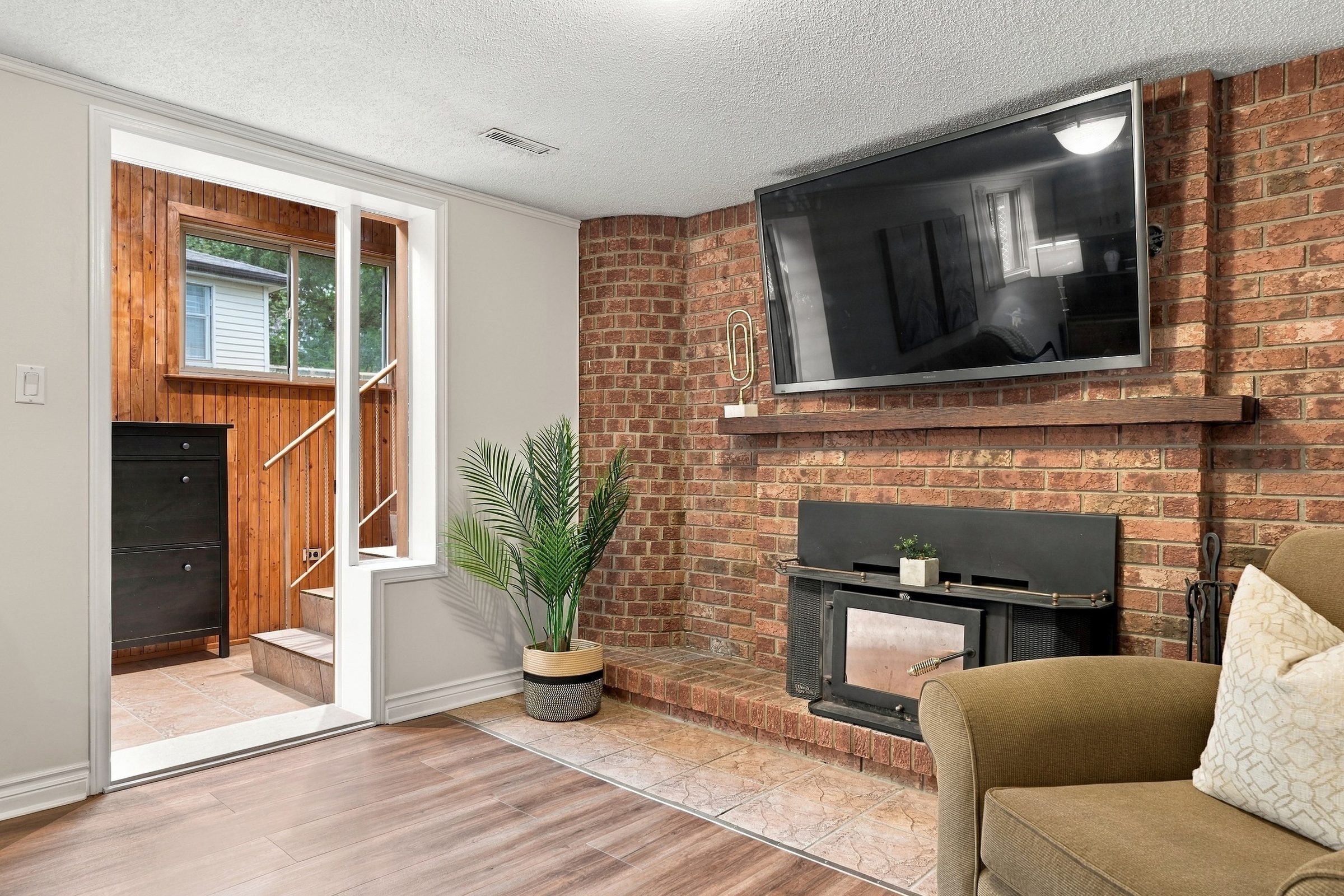 Brick wood-burning fireplace and rear entry at 476 Michelle Row, Mississauga