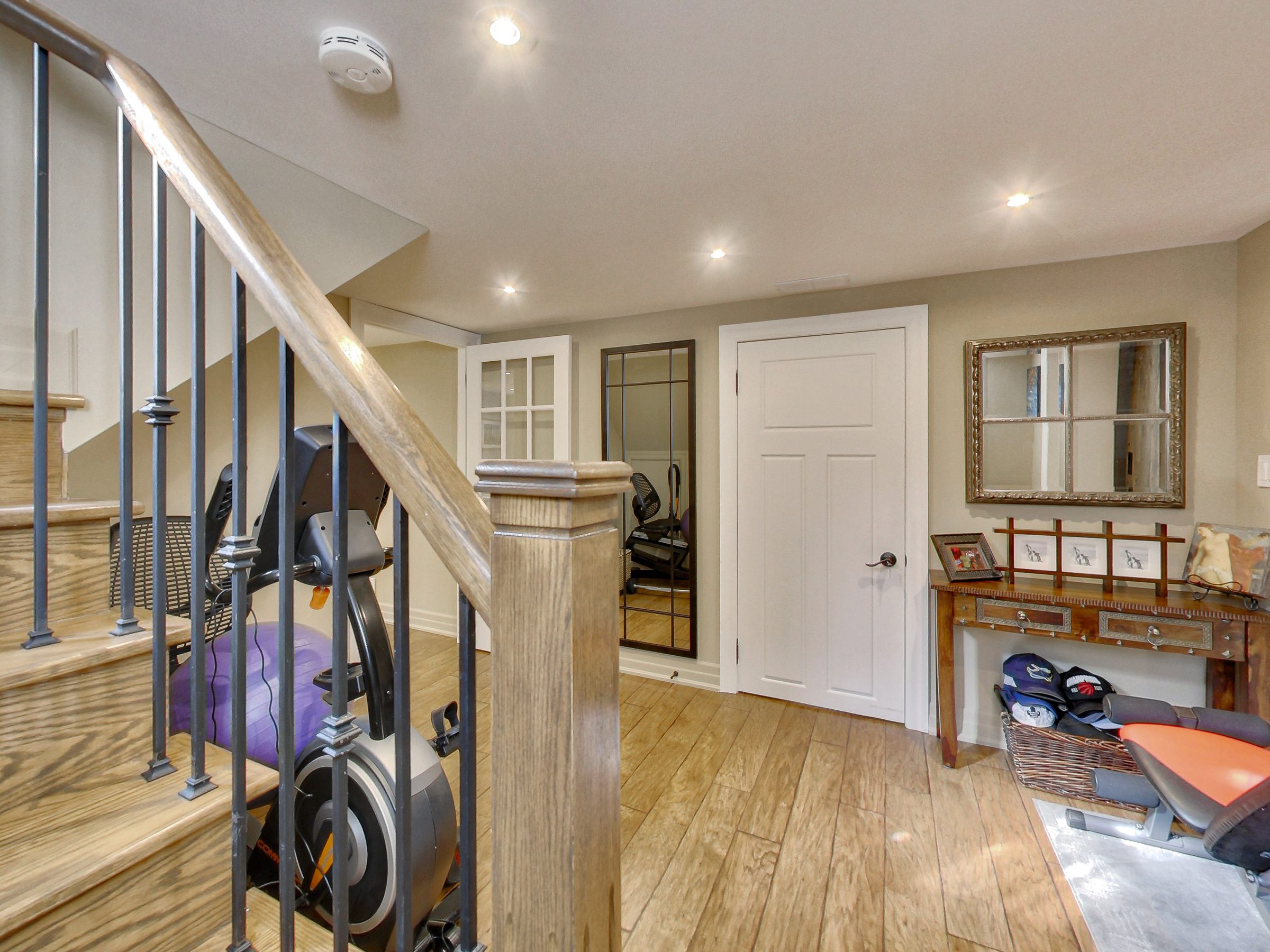 Foyer with oak staircase in the lower suite at 51 Norseman Street, Toronto
