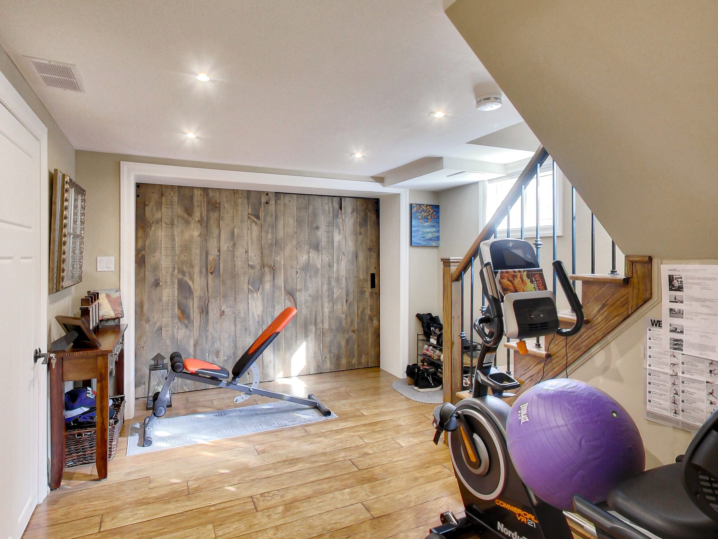 Foyer with sliding barn door in the lower suite at 51 Norseman Street, Toronto