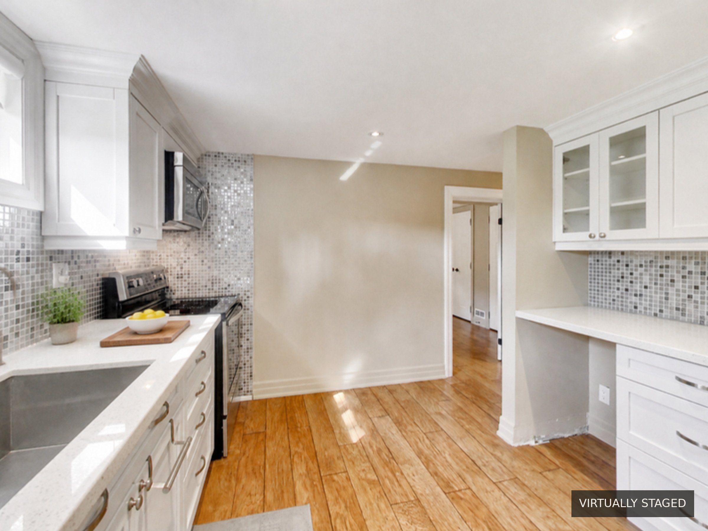 Kitchen looking toward the bedroom, virtually staged, at 51 Norseman Street, Toronto