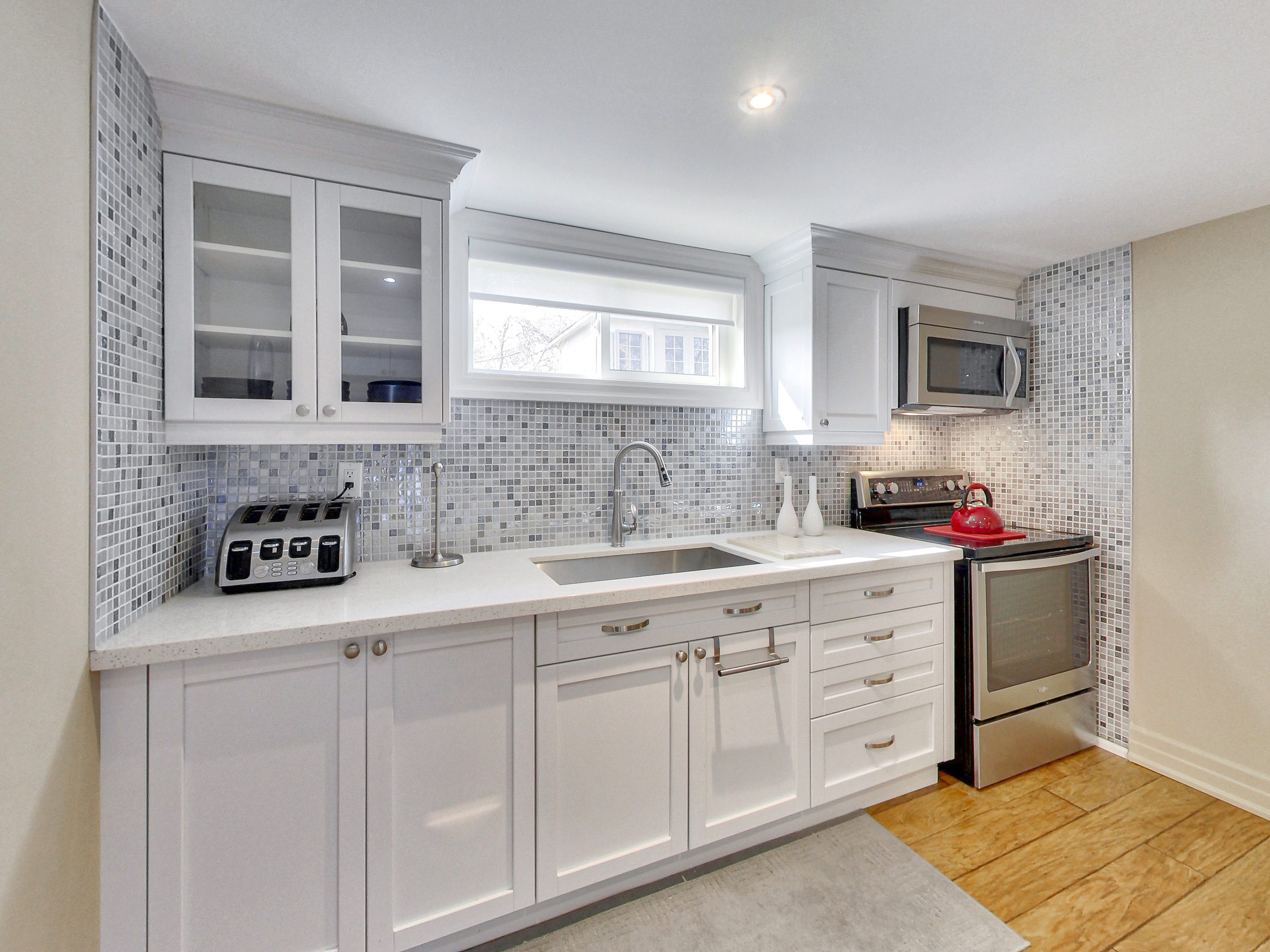 Renovated white shaker kitchen at the lower suite, 51 Norseman Street, Toronto