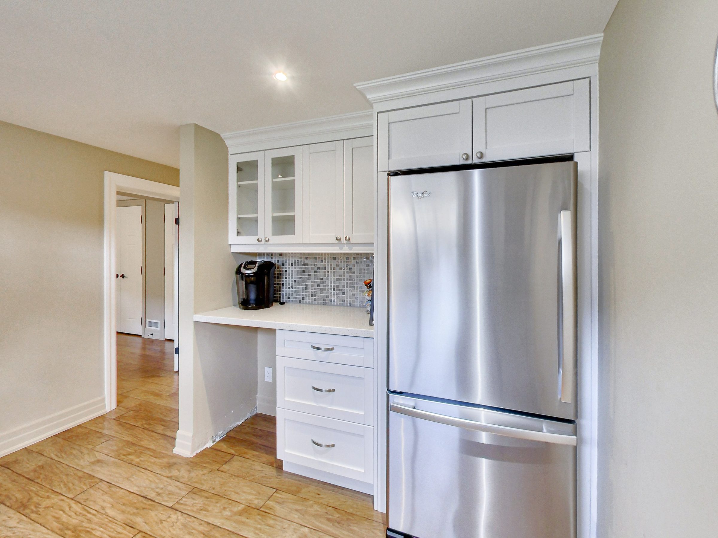 Kitchen fridge and glass-front cabinets at 51 Norseman Street, Toronto