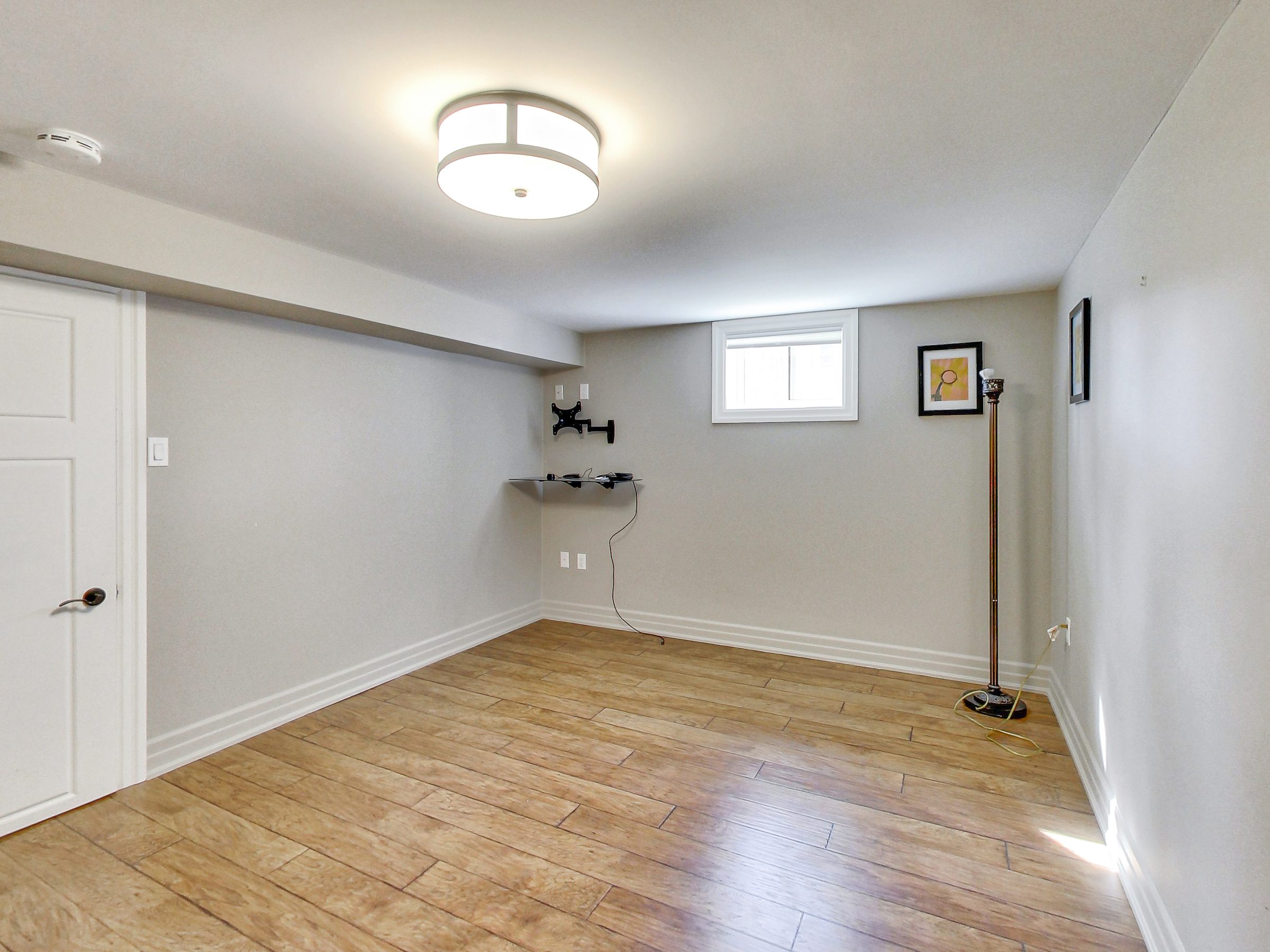 Bedroom with window in the lower suite at 51 Norseman Street, Toronto