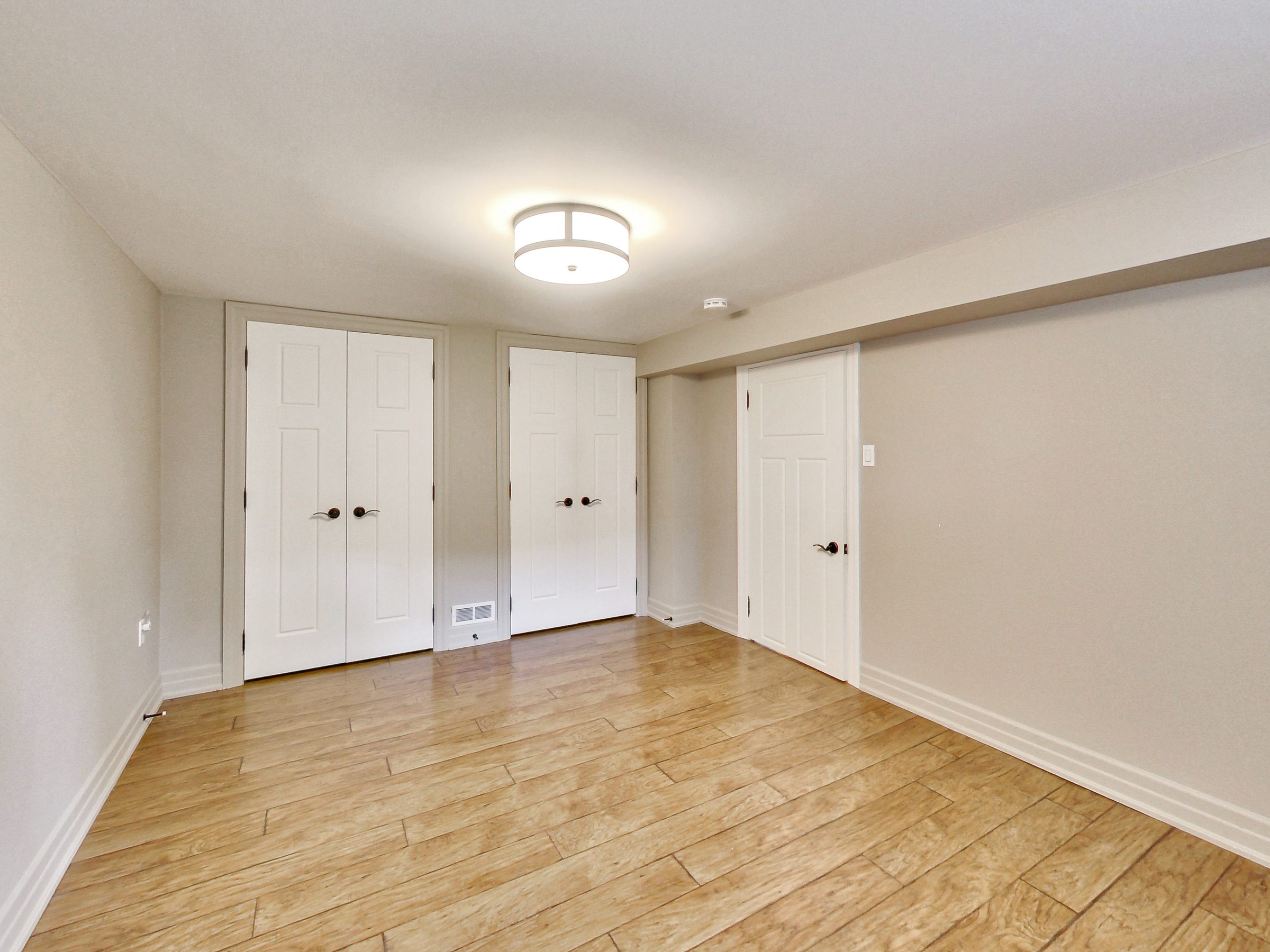 Bedroom with double-door closets at 51 Norseman Street, Toronto