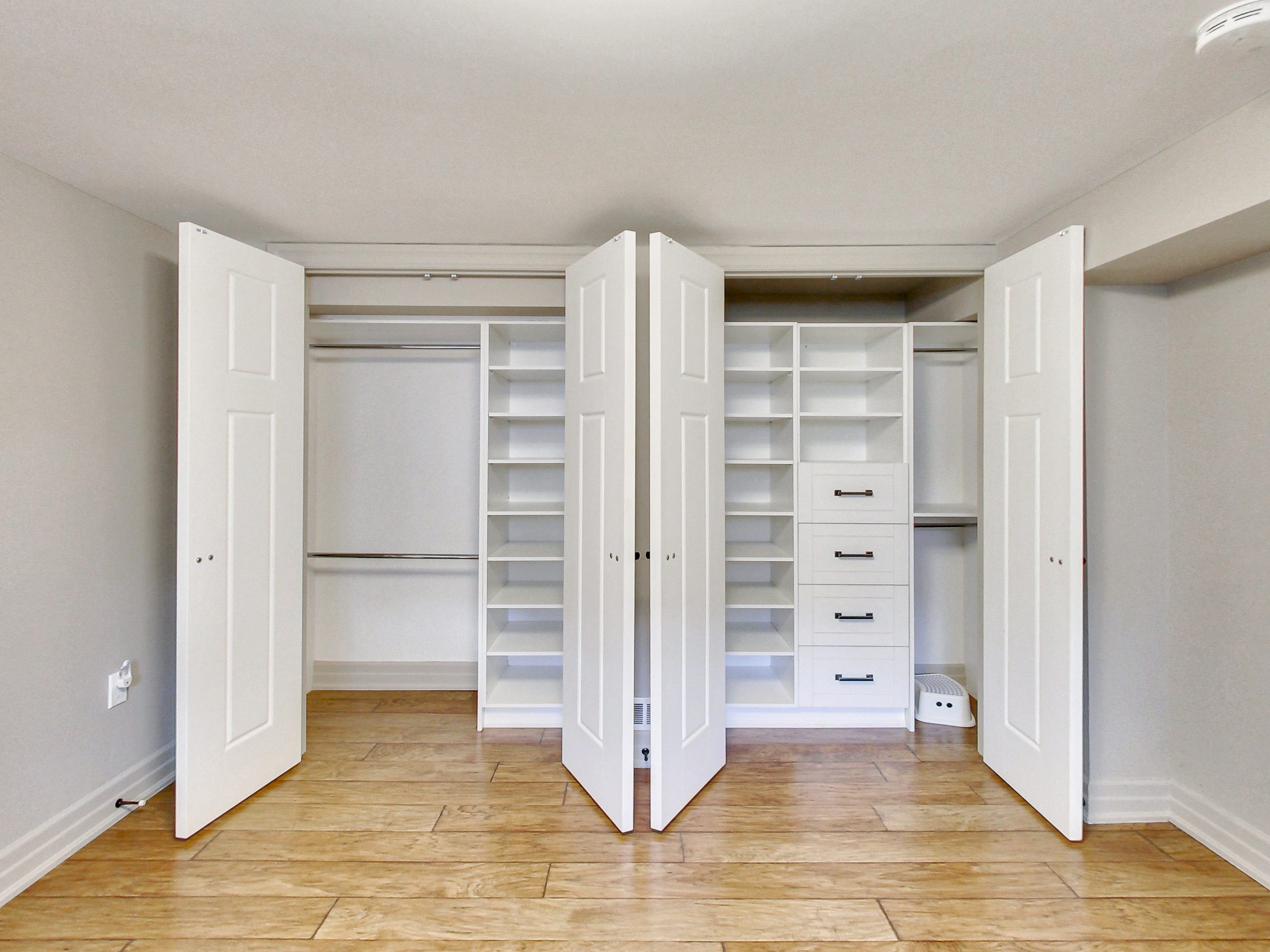 Custom closet organizers in the bedroom at 51 Norseman Street, Toronto