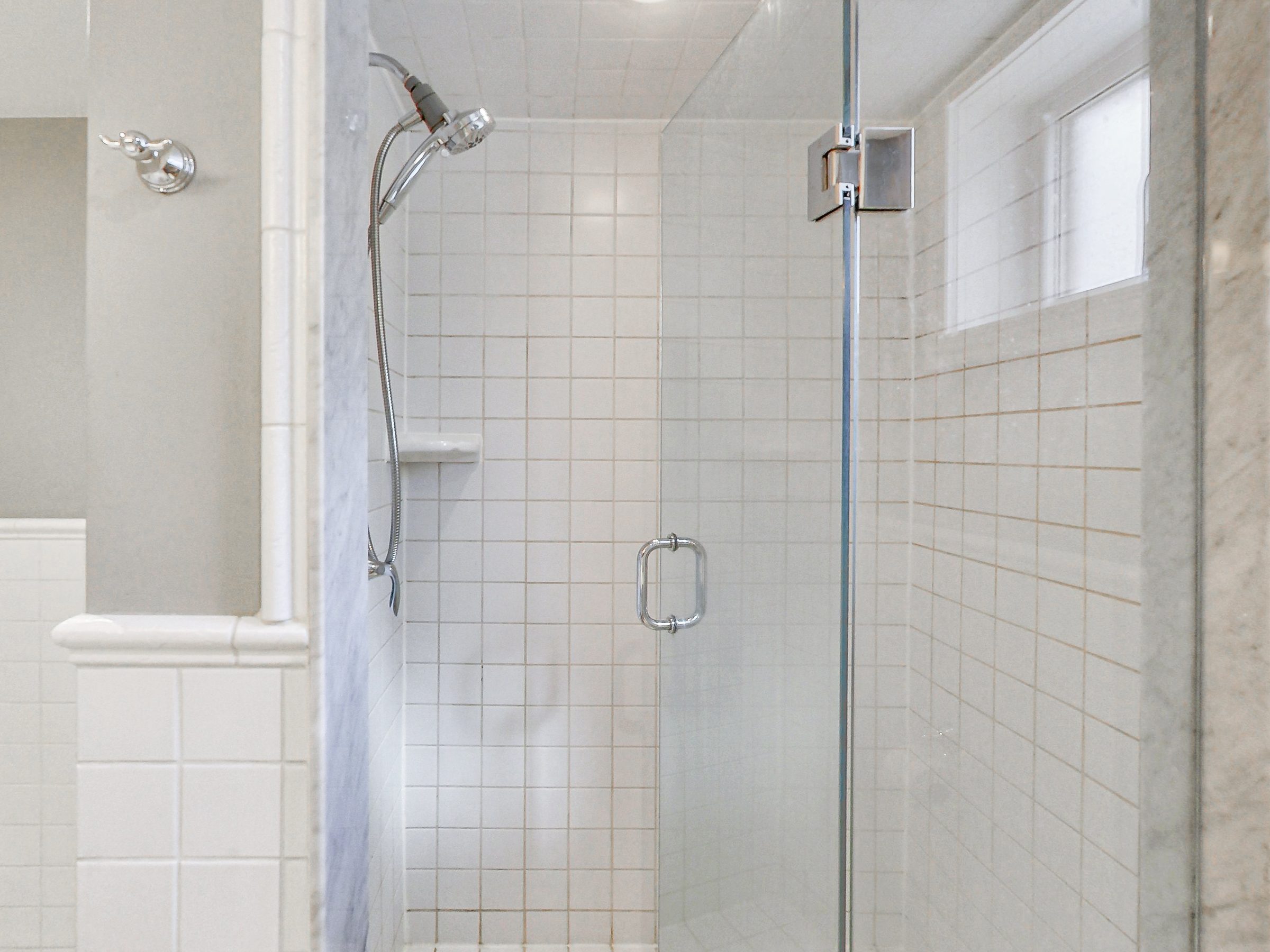 Frameless glass shower in the bathroom at 51 Norseman Street, Toronto