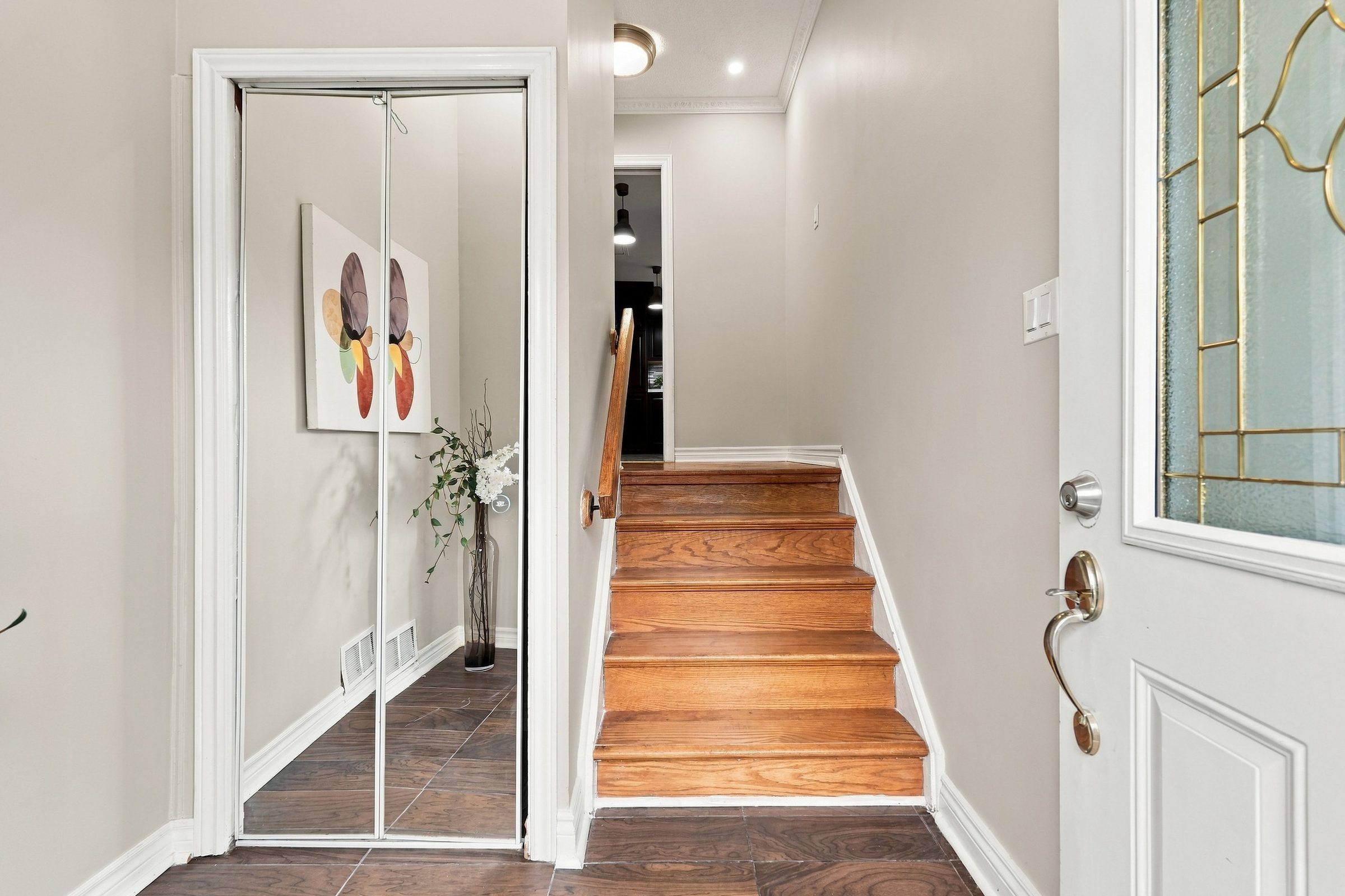 Front foyer with hardwood stairs at 7179 Delmonte Crescent