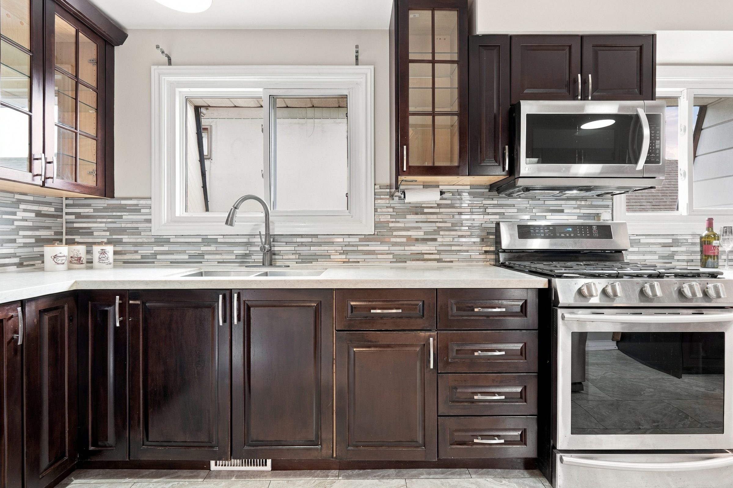 Kitchen with espresso cabinetry and gas range at 7179 Delmonte Crescent