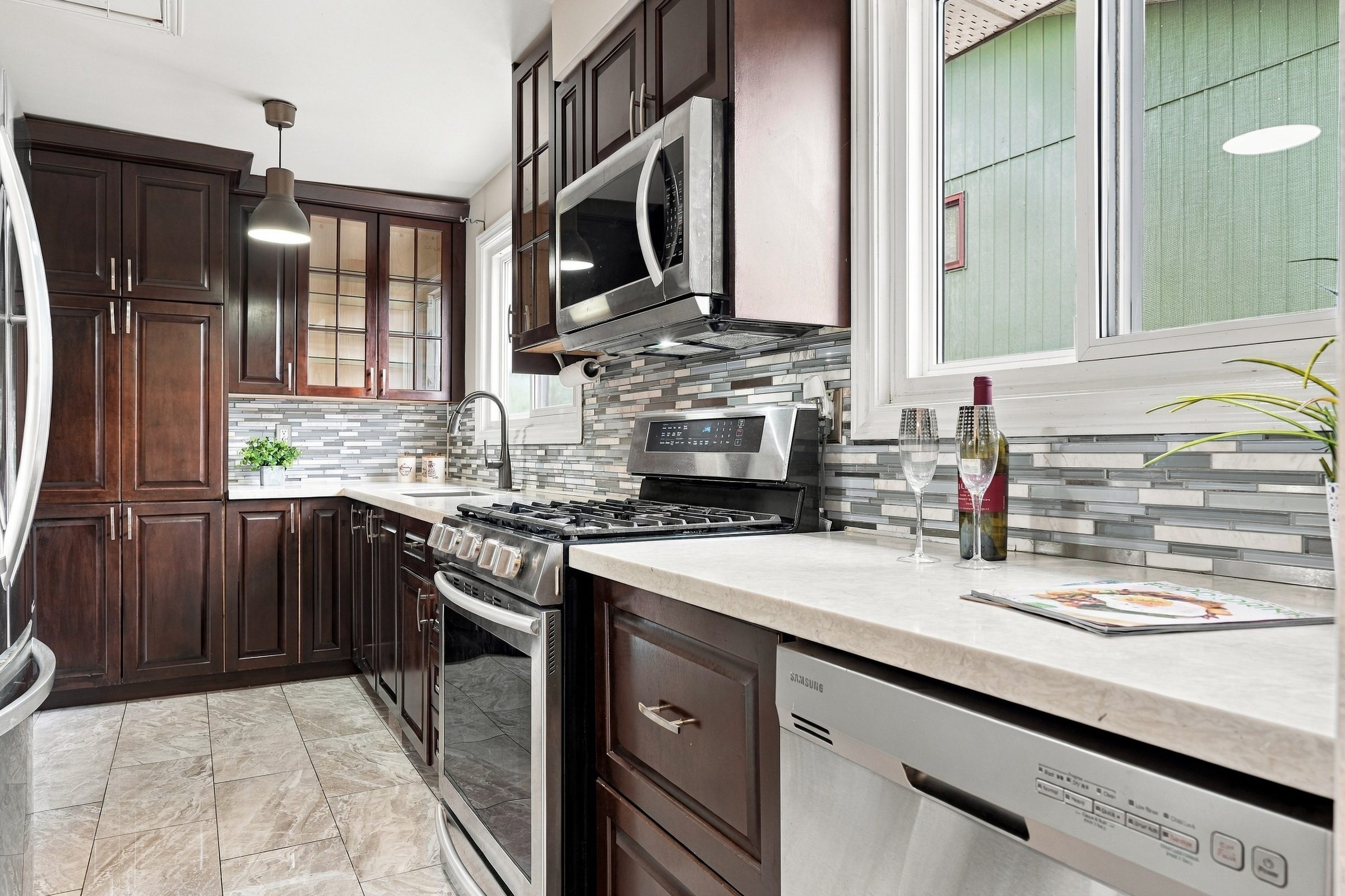 Kitchen counters and glass-mosaic backsplash at 7179 Delmonte Crescent