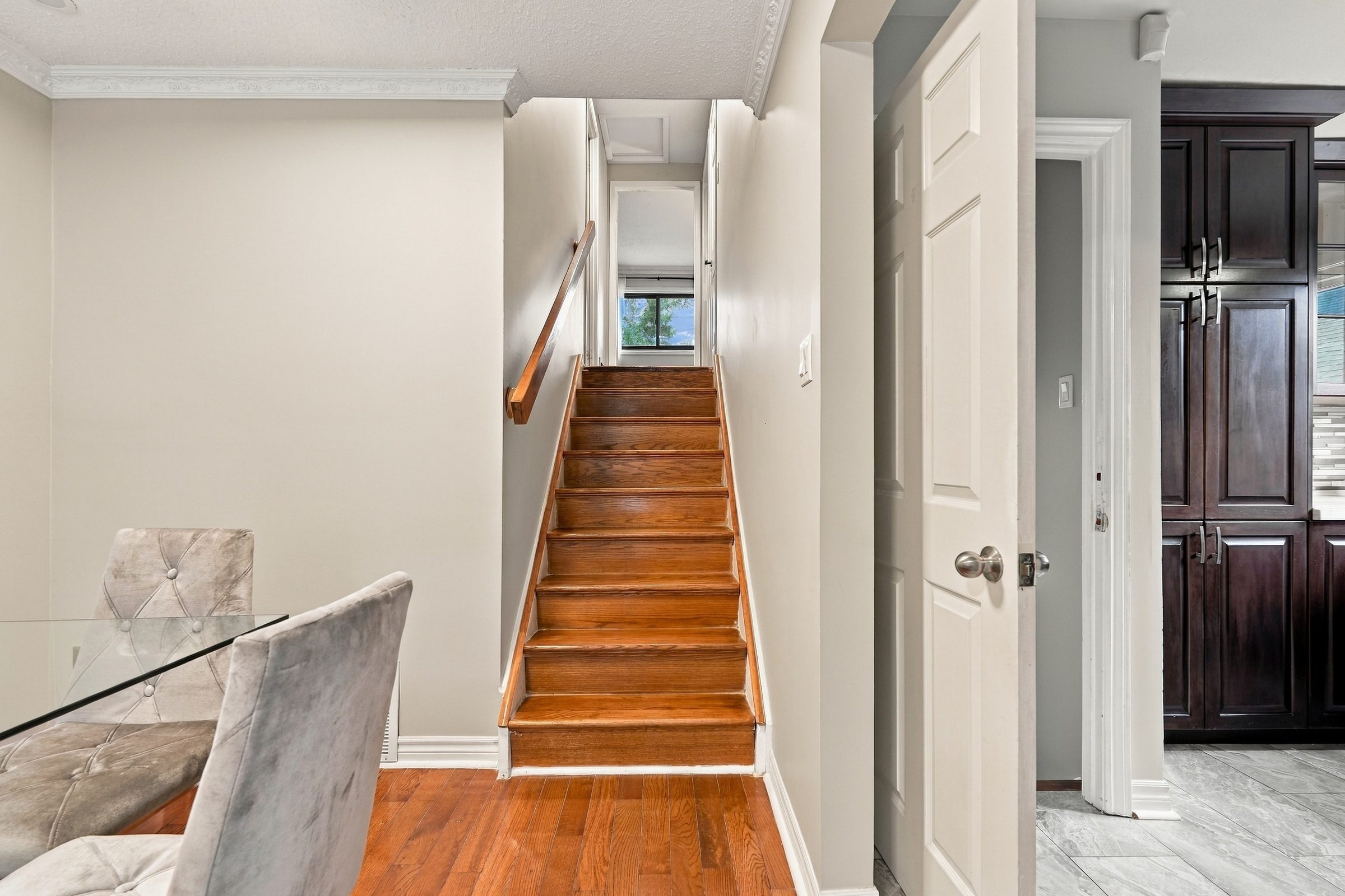 Stairs from the dining area to the bedroom level at 7179 Delmonte Crescent