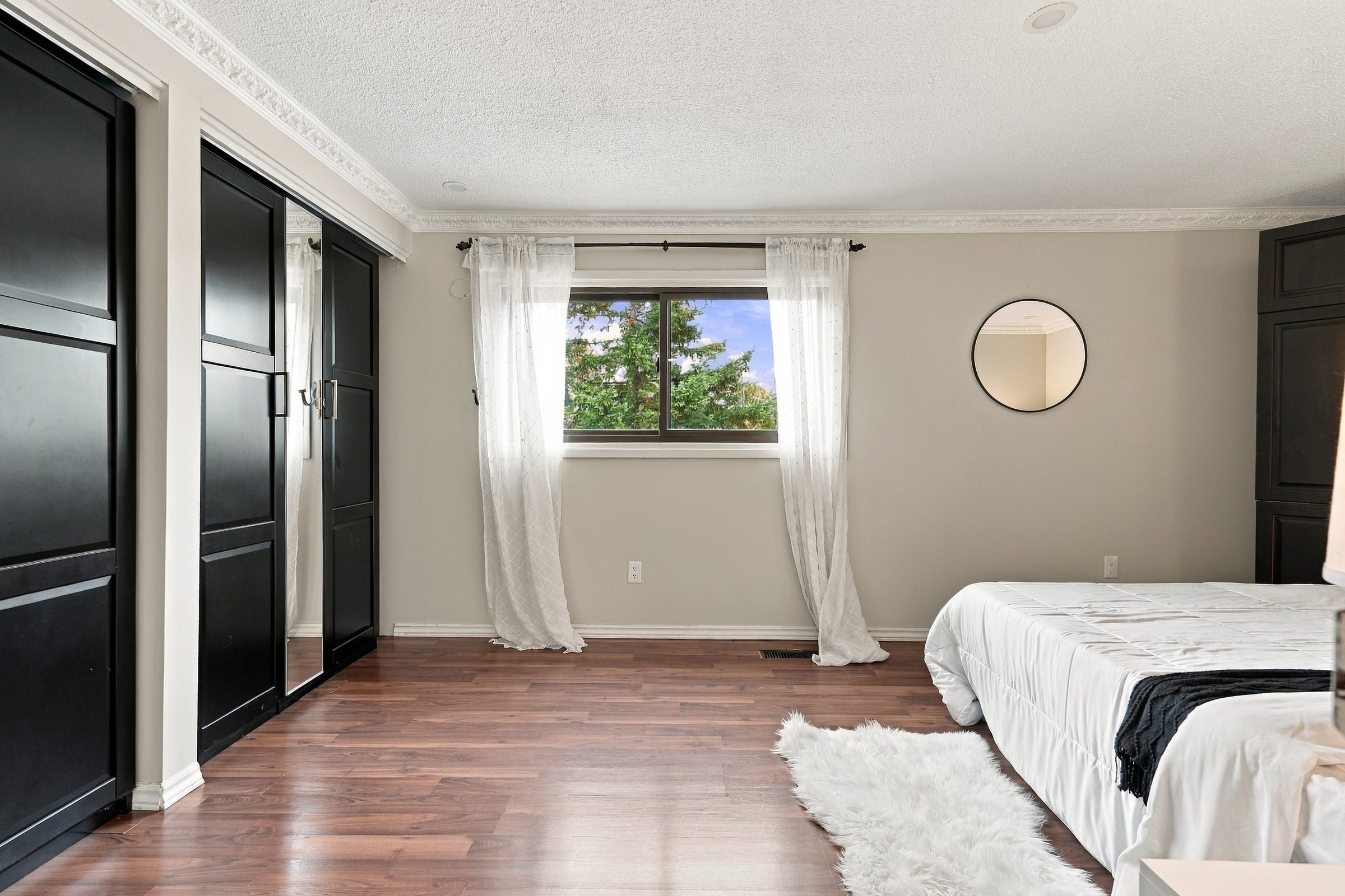 Primary bedroom with wardrobe closets at 7179 Delmonte Crescent