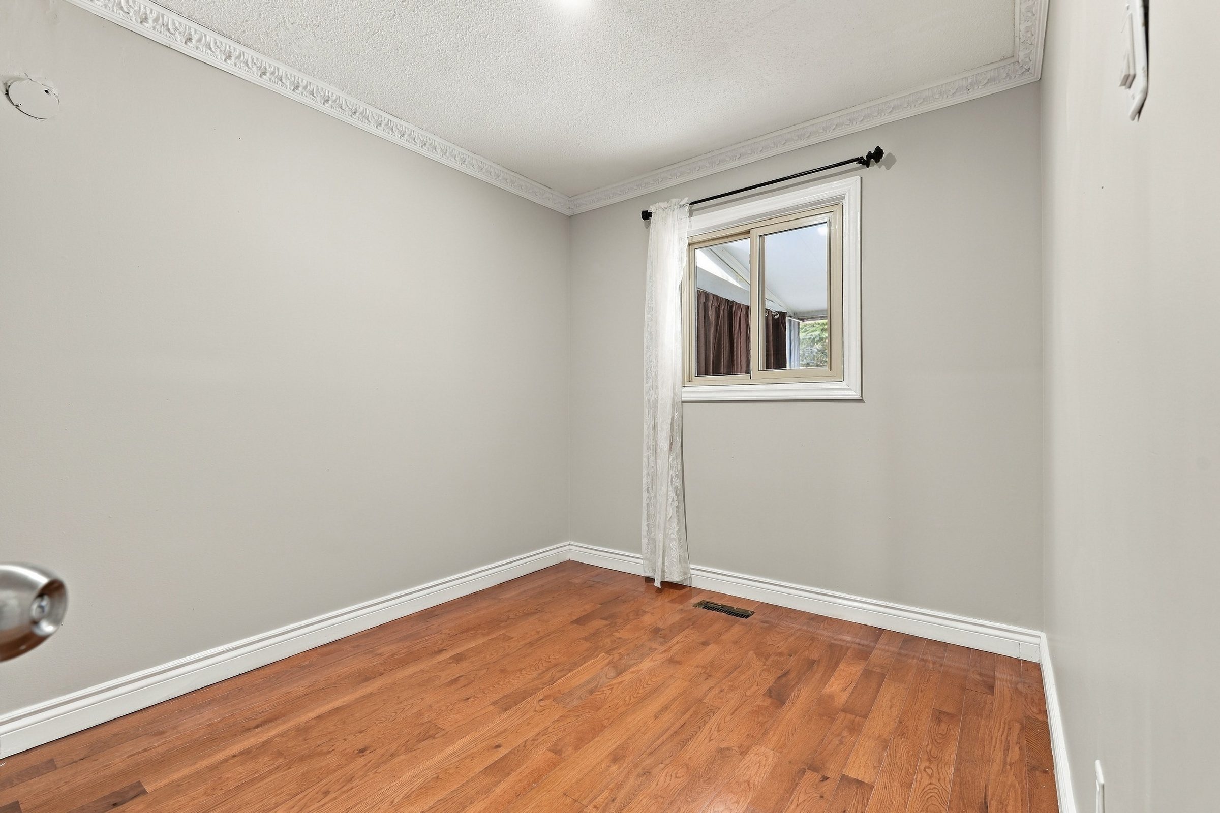 Bedroom with hardwood floors at 7179 Delmonte Crescent