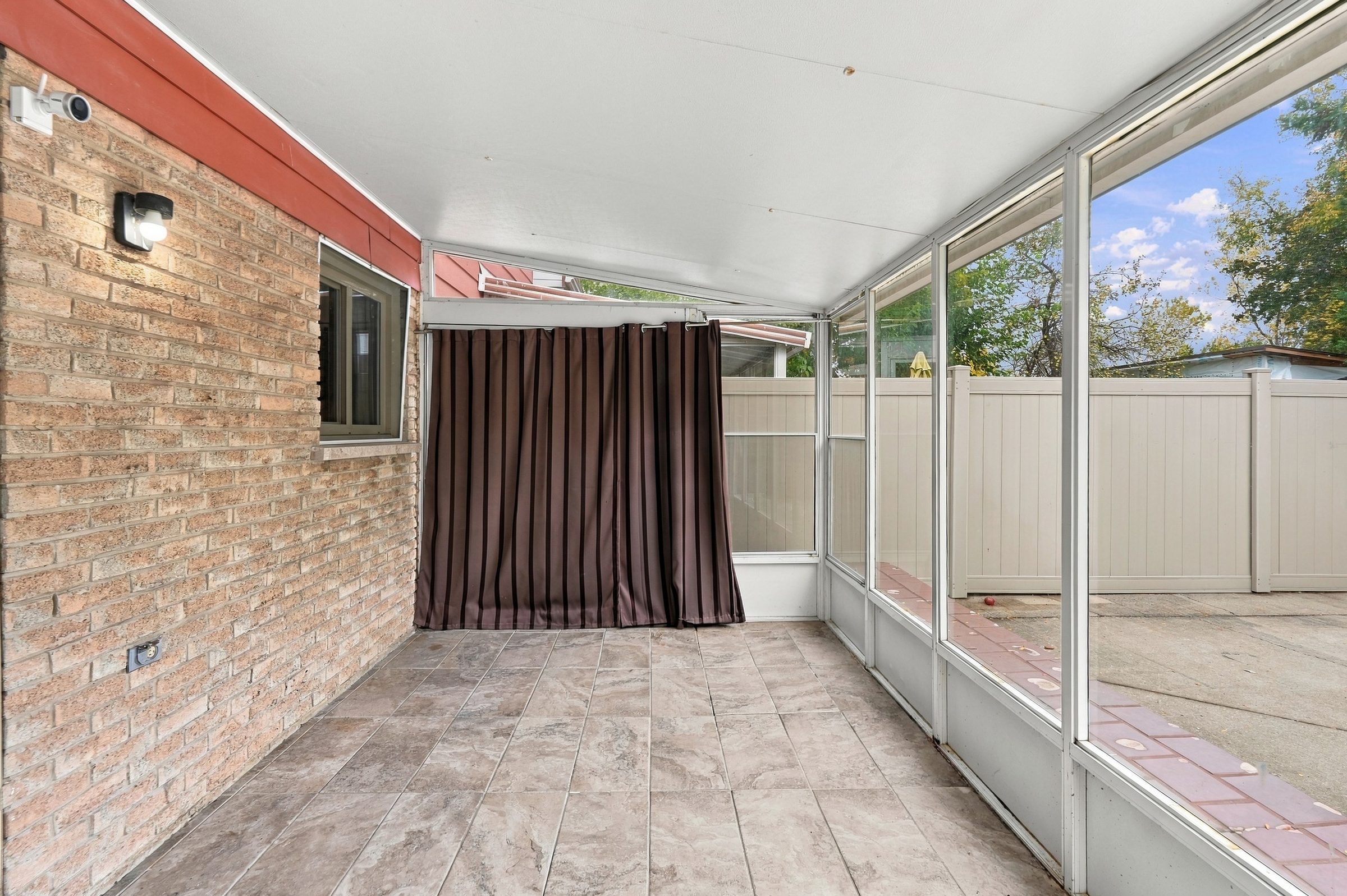 Sunroom with tiled floor at 7179 Delmonte Crescent