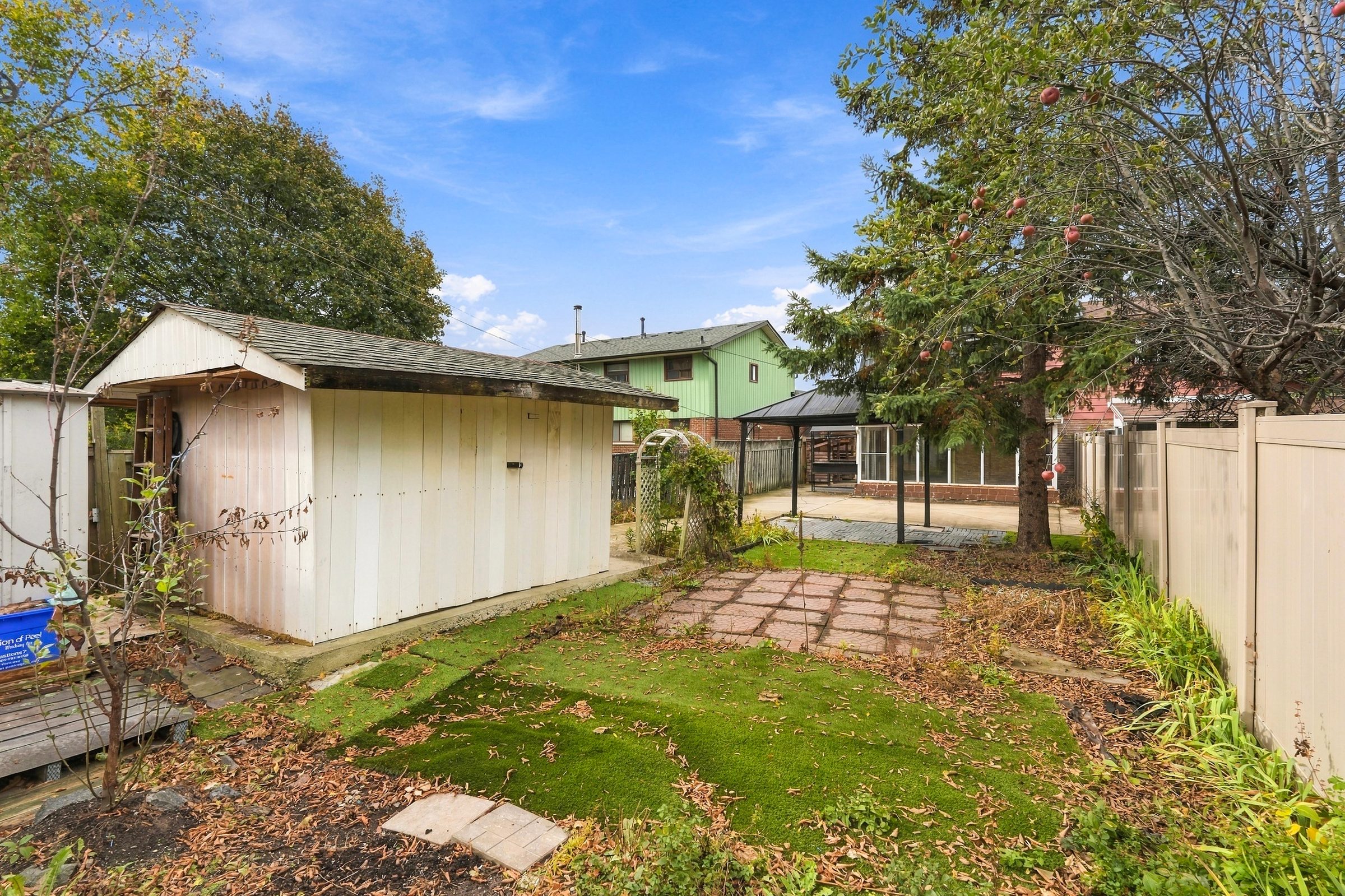 Deep backyard lawn and garden shed at 7179 Delmonte Crescent