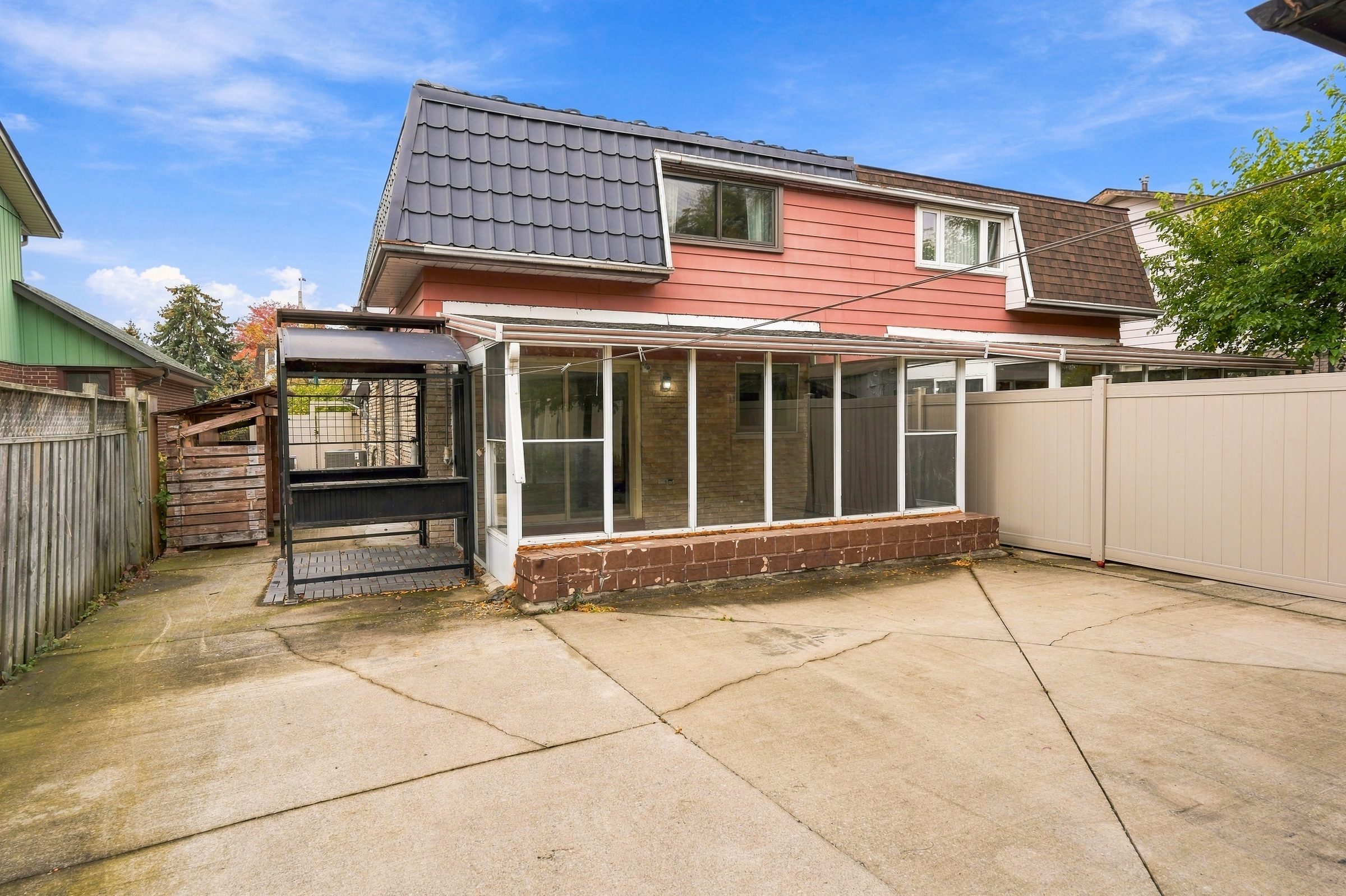 Rear of the house and sunroom at 7179 Delmonte Crescent