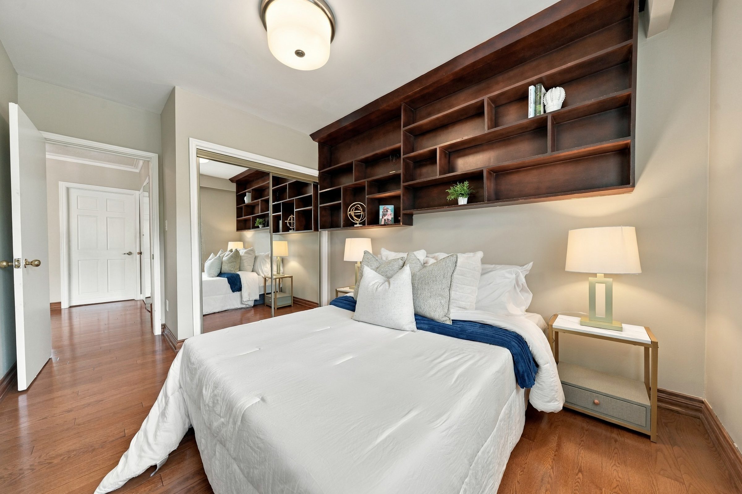 Bedroom with built-in wood shelving