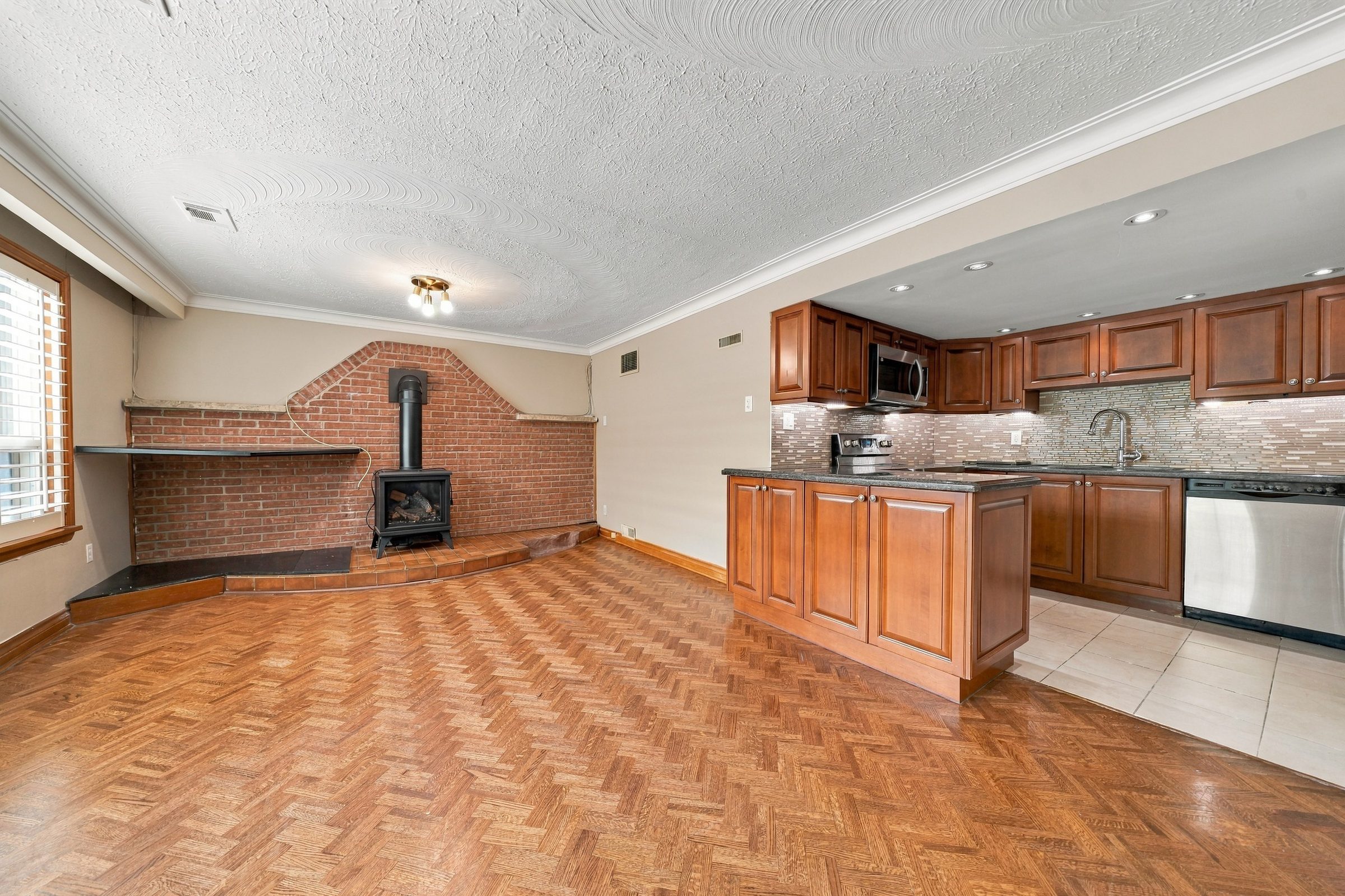 Lower-level family room with a natural gas stove and second kitchen