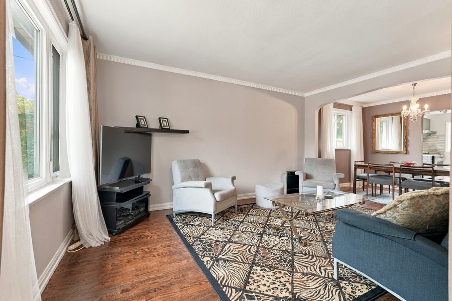 Living room with hardwood floors and a large front window