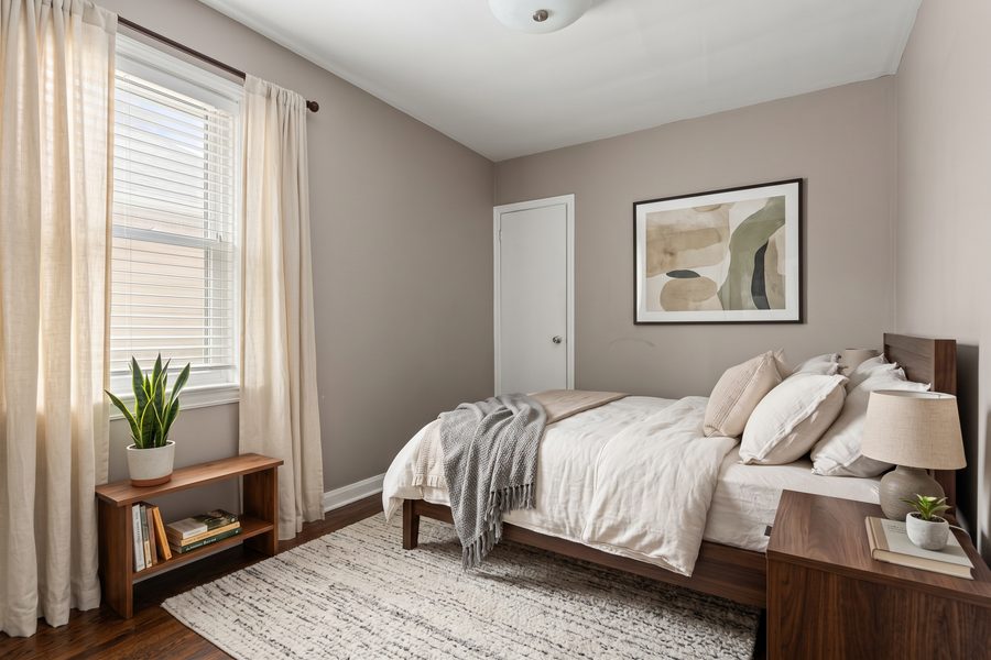 Virtually staged rendering of a bedroom with a queen bed, nightstands and window